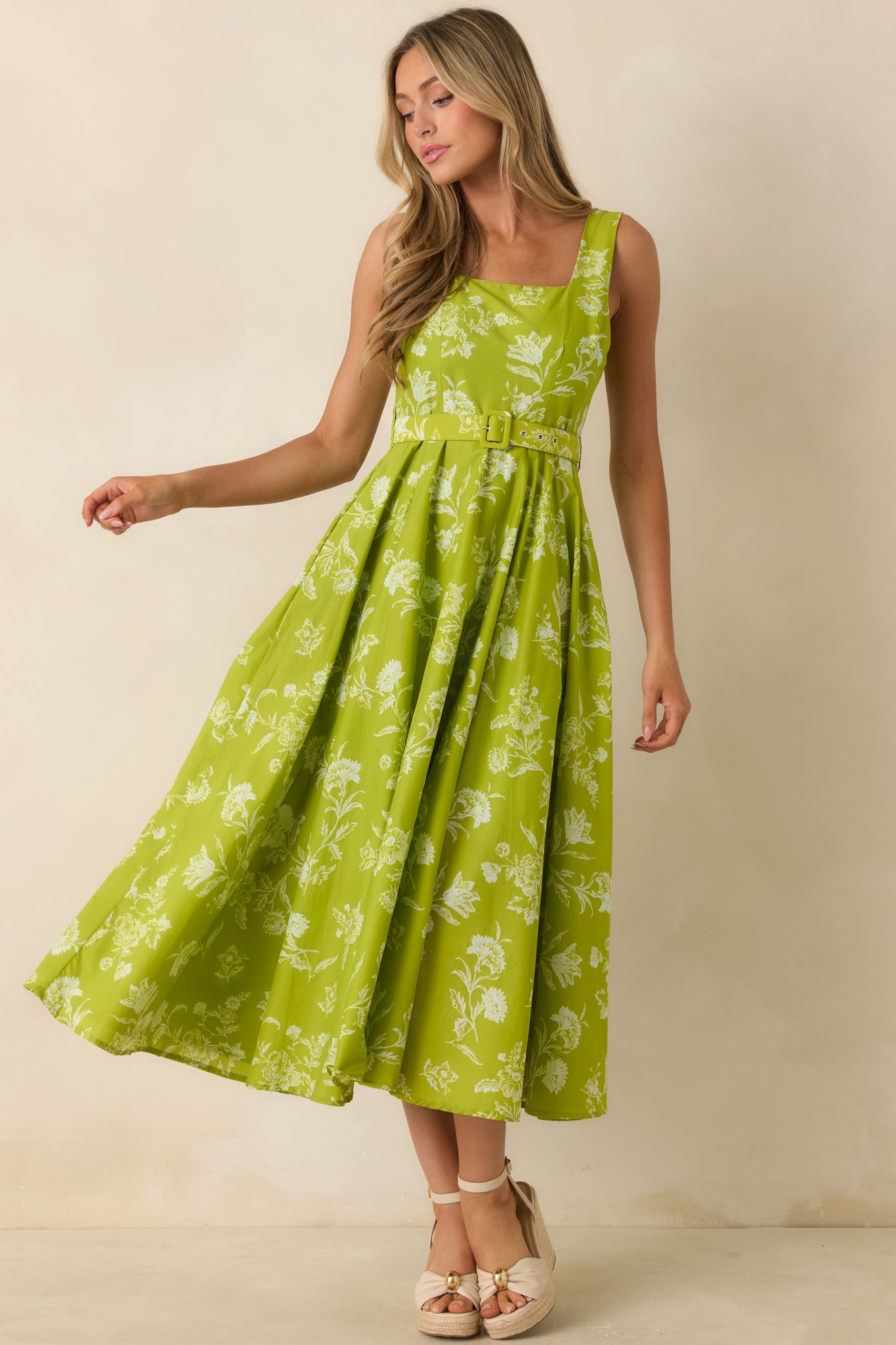 Cotton midi dress in a chartreuse floral print with a polished silhouette, side pockets, and elegant gathered detailing throughout the skirt.