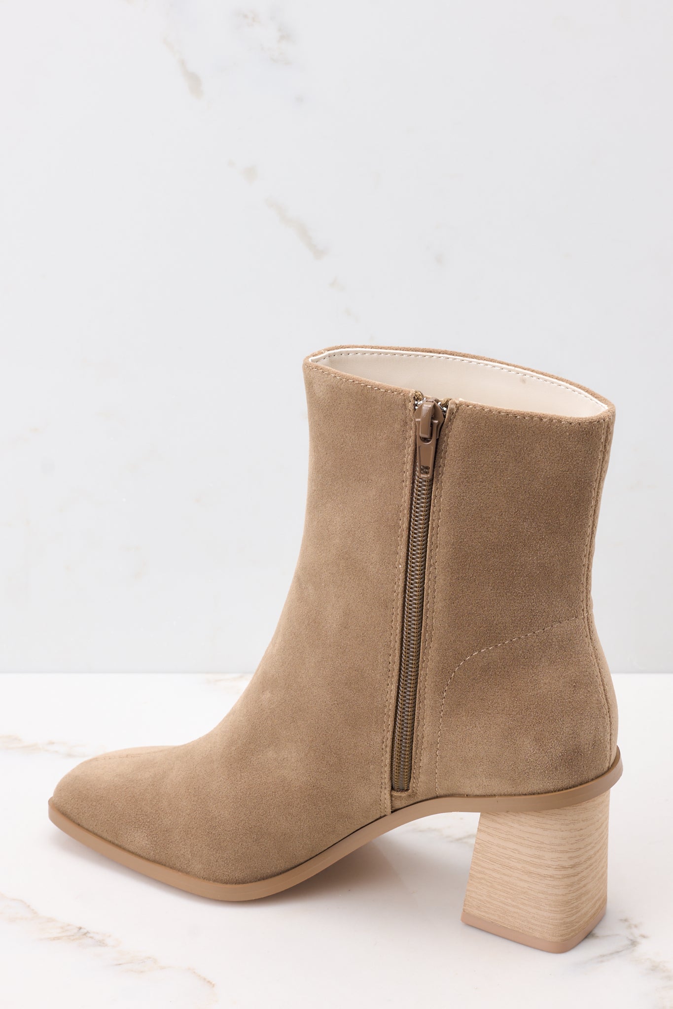 Inside view of taupe high heel booties with a full inside zipper.