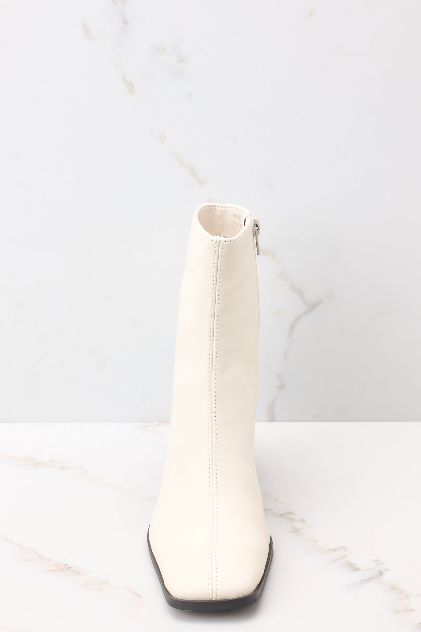 Front view of beige booties with a slightly squared toe.