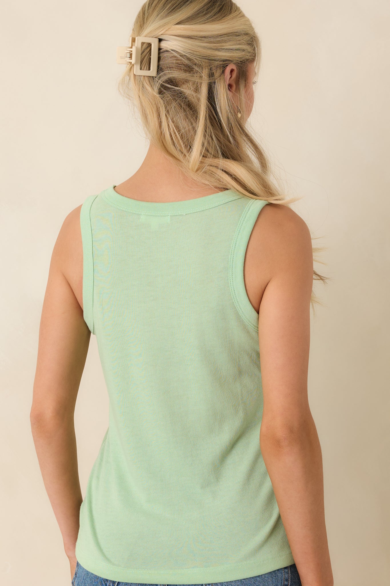 Green sleeveless tank top rear view featuring a clean, fitted silhouette and smooth finish.