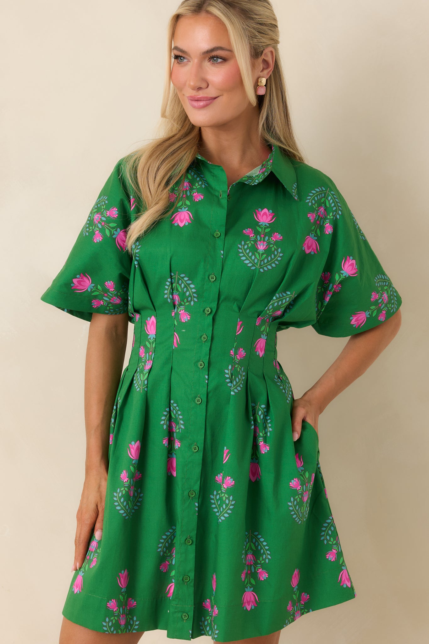 Detailed look at the mini dress waistline and smooth fabric finish.