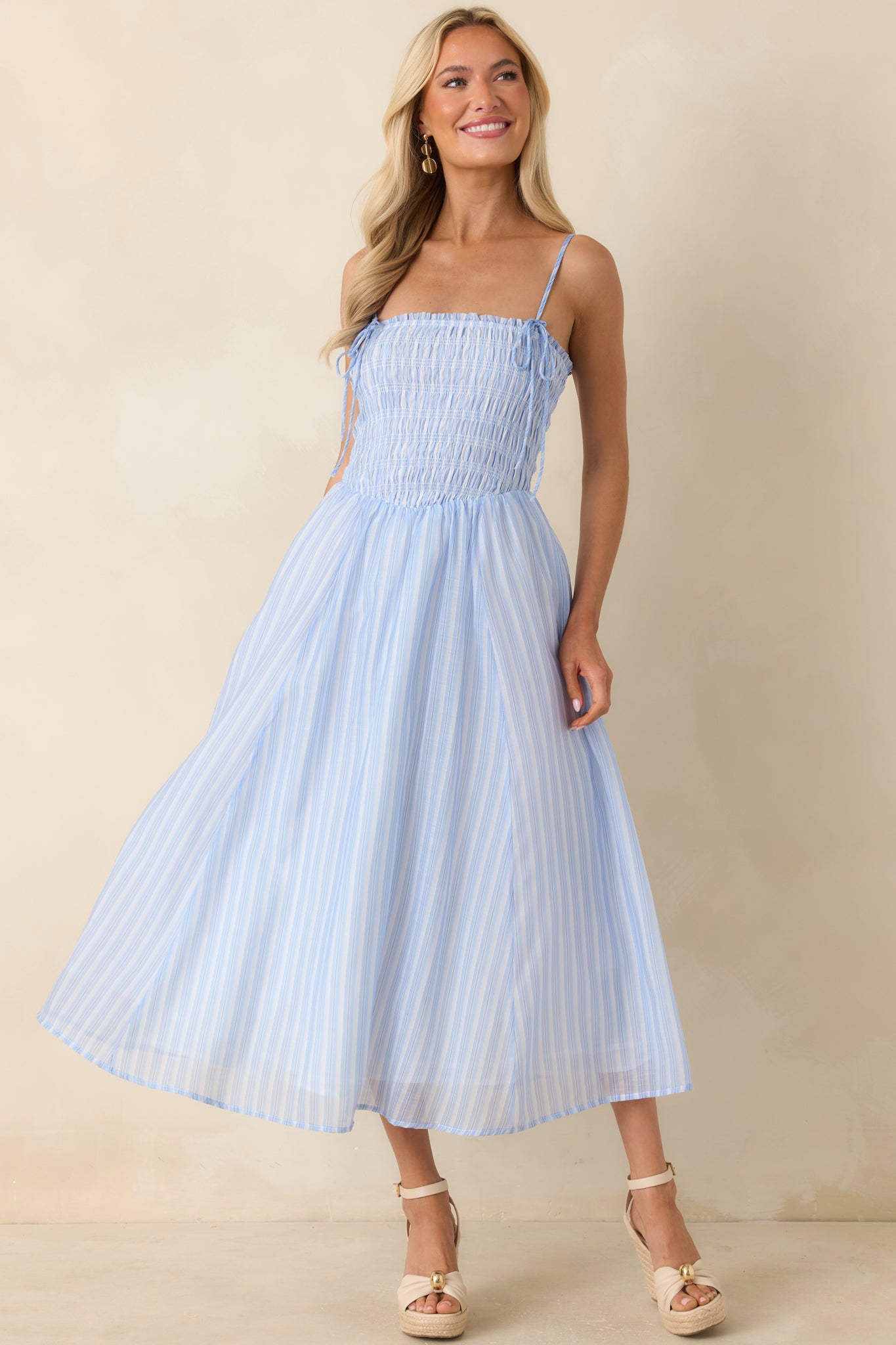 Light blue and white dress with a flattering fitted upper bodice and a gently flared midi skirt.