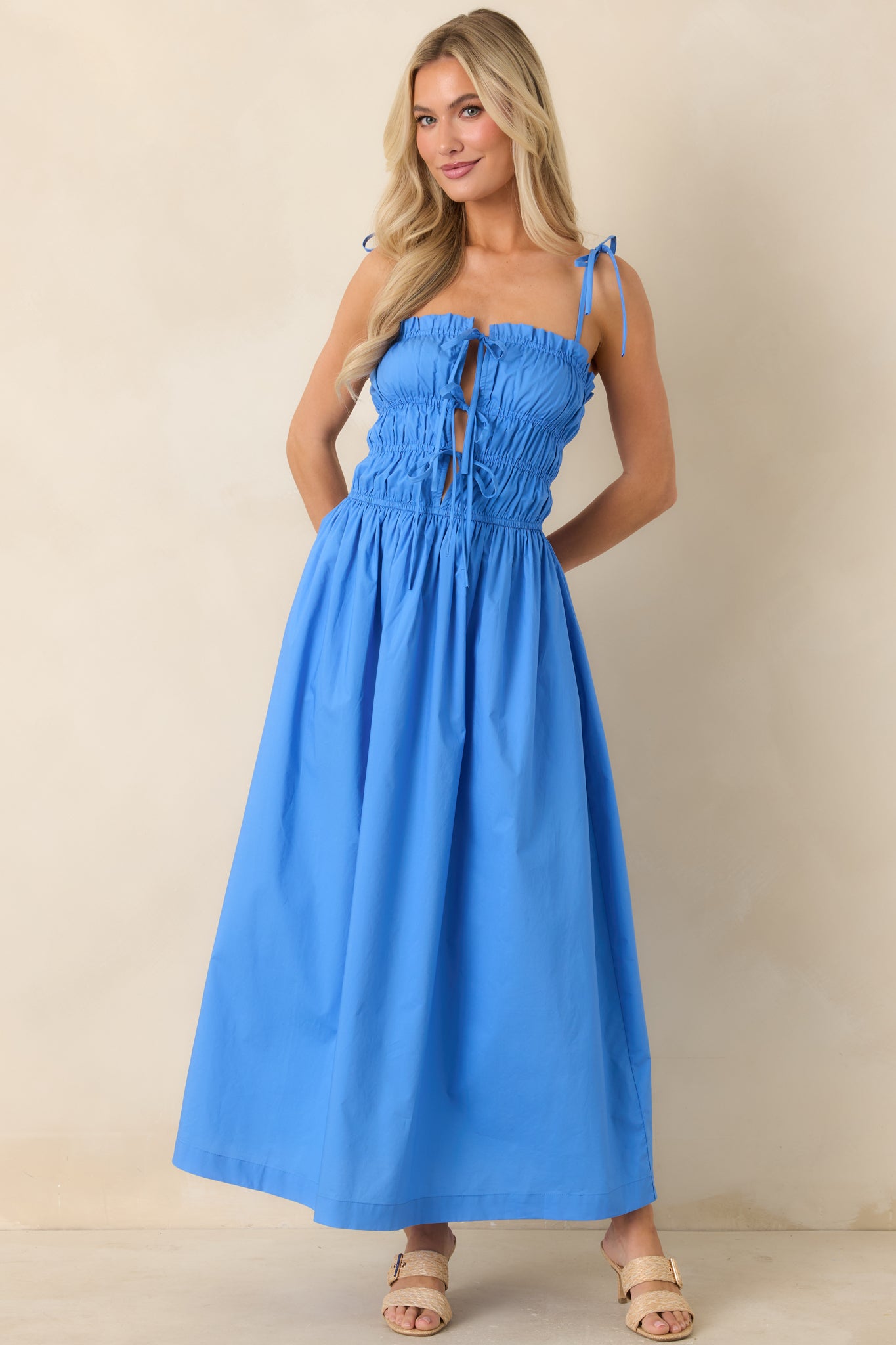 Lightweight midi dress with open-back feel and softly gathered waist shaping.