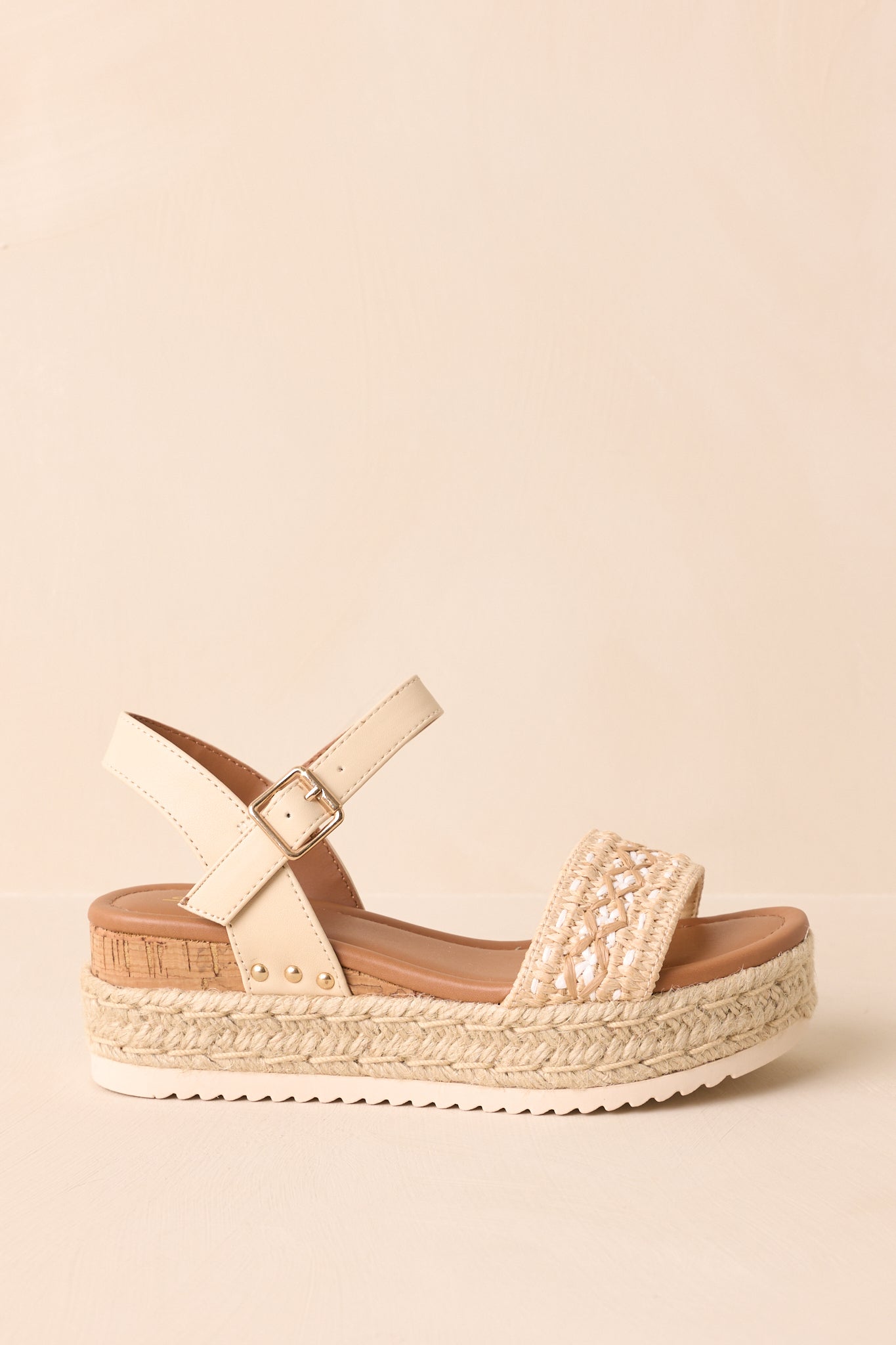 Side cropped view highlighting the faux leather ankle and heel straps and jute-wrapped platform sole.