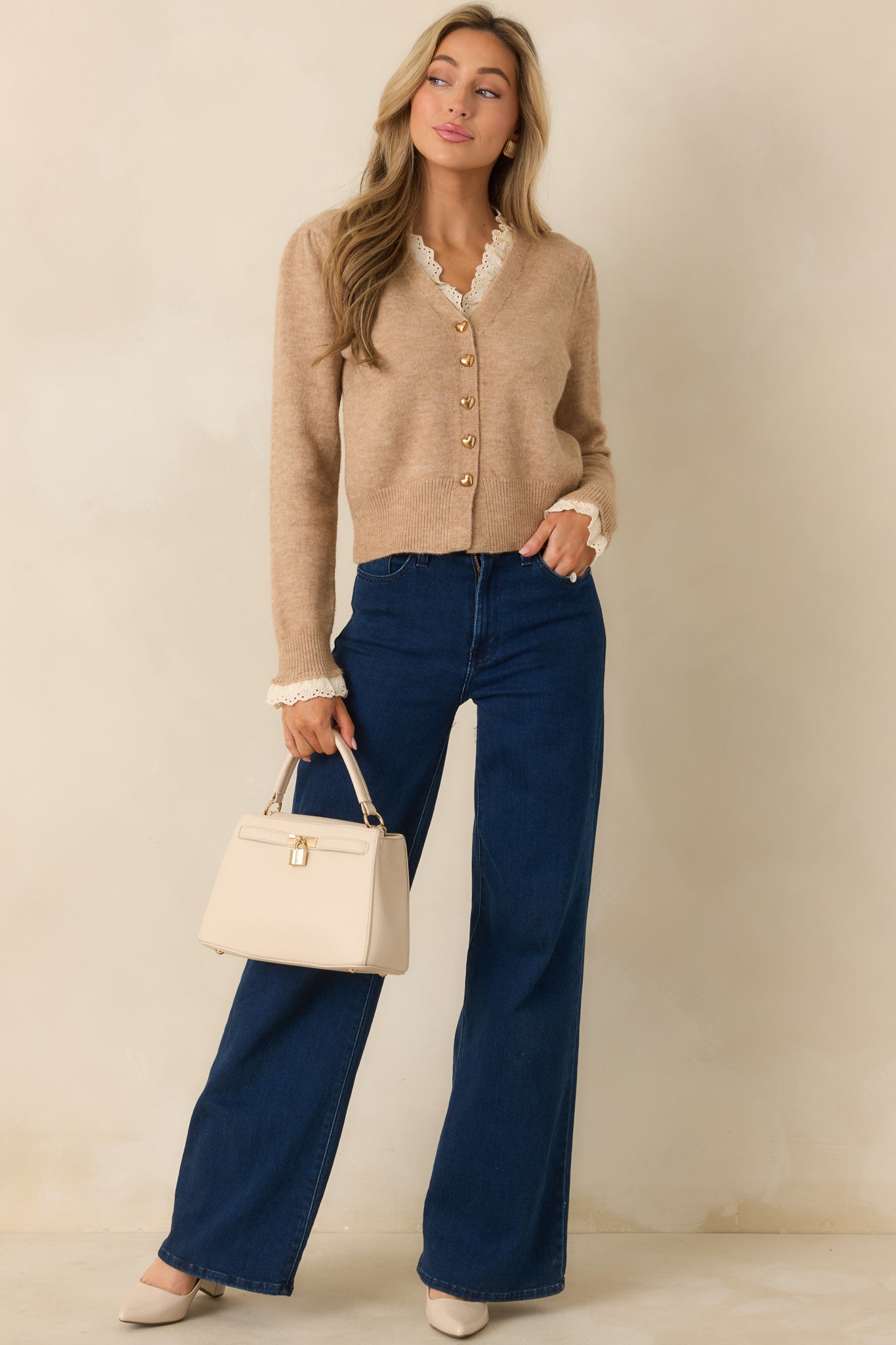 V-neck taupe cardigan with floral lace edging and a classic layering-friendly knit weight.