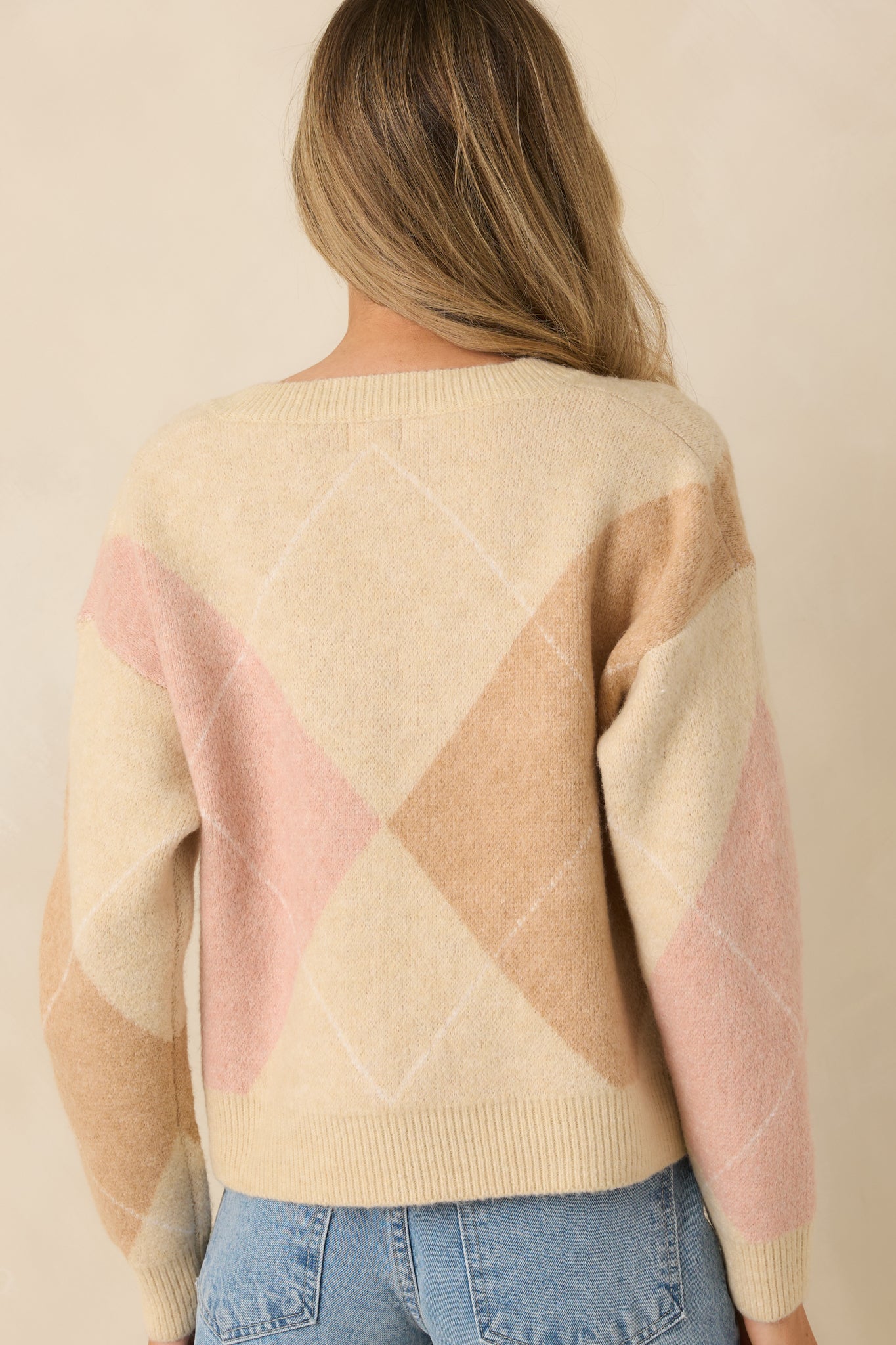Back view of taupe multi-knit argyle sweater highlighting long sleeves and ribbed hem and cuffs.