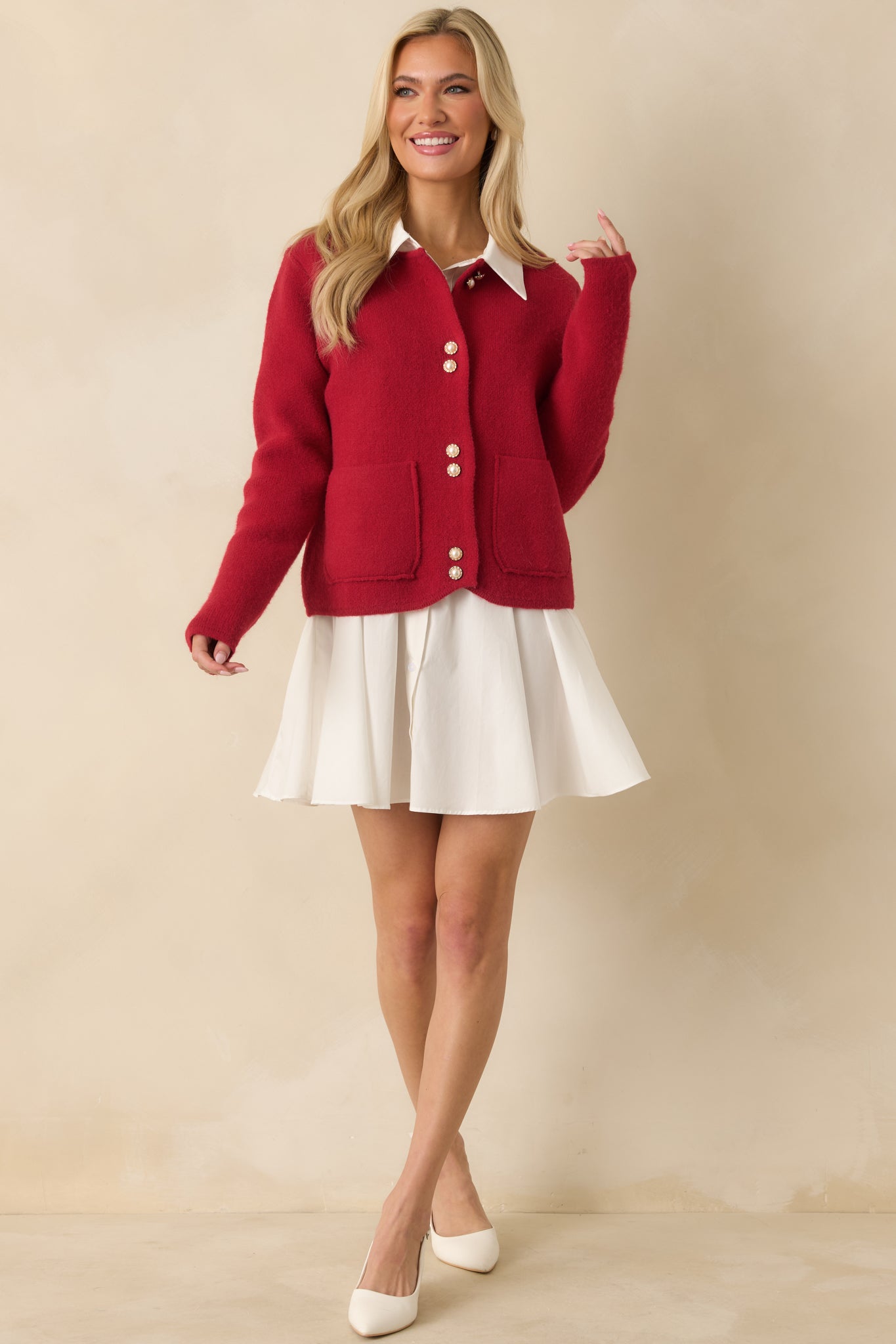 Relaxed-fit red cardigan featuring button closure and casual silhouette.