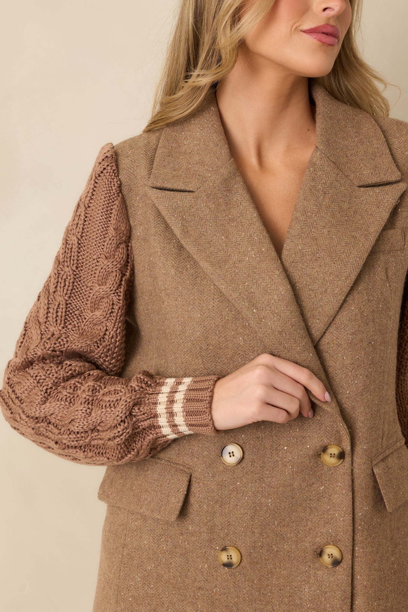 Close-up of the cable-knit sleeve texture emphasizing ribbed cuffs and stripe accents.