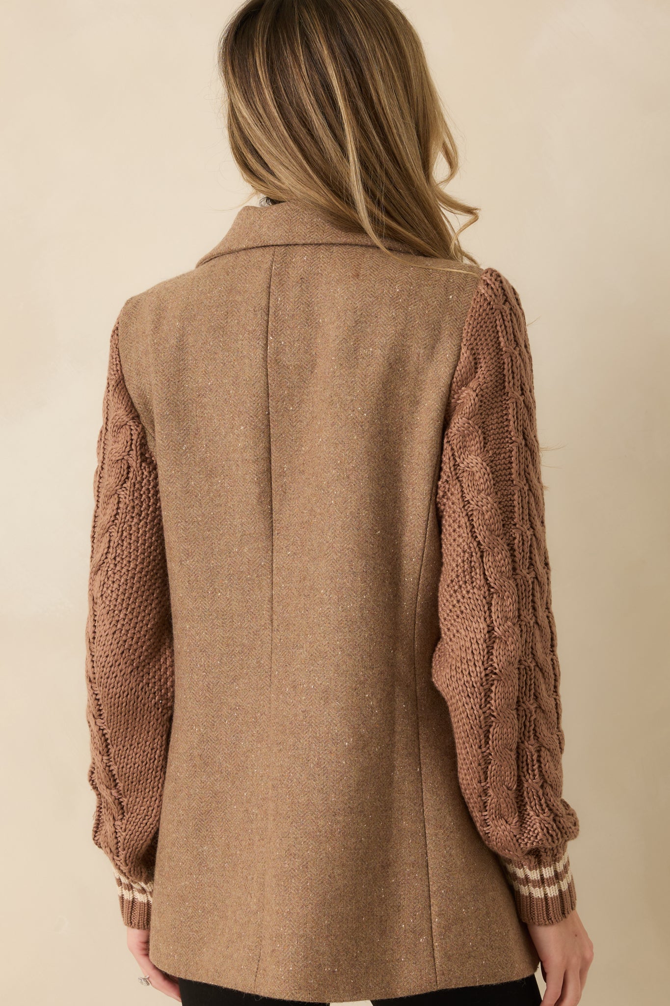 Rear view of the camel blazer showing a clean structured finish and knit sleeve contrast.
