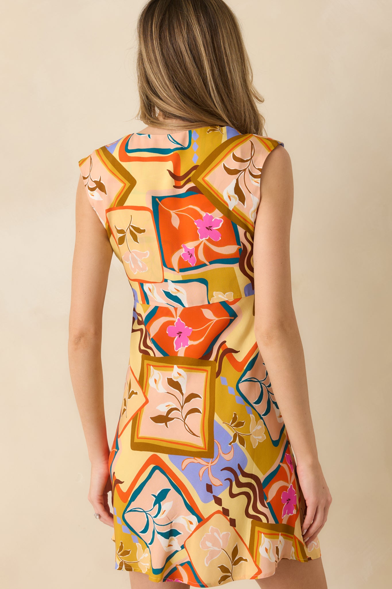 Rear view of the mini dress showing the clean finish and smooth woven drape.