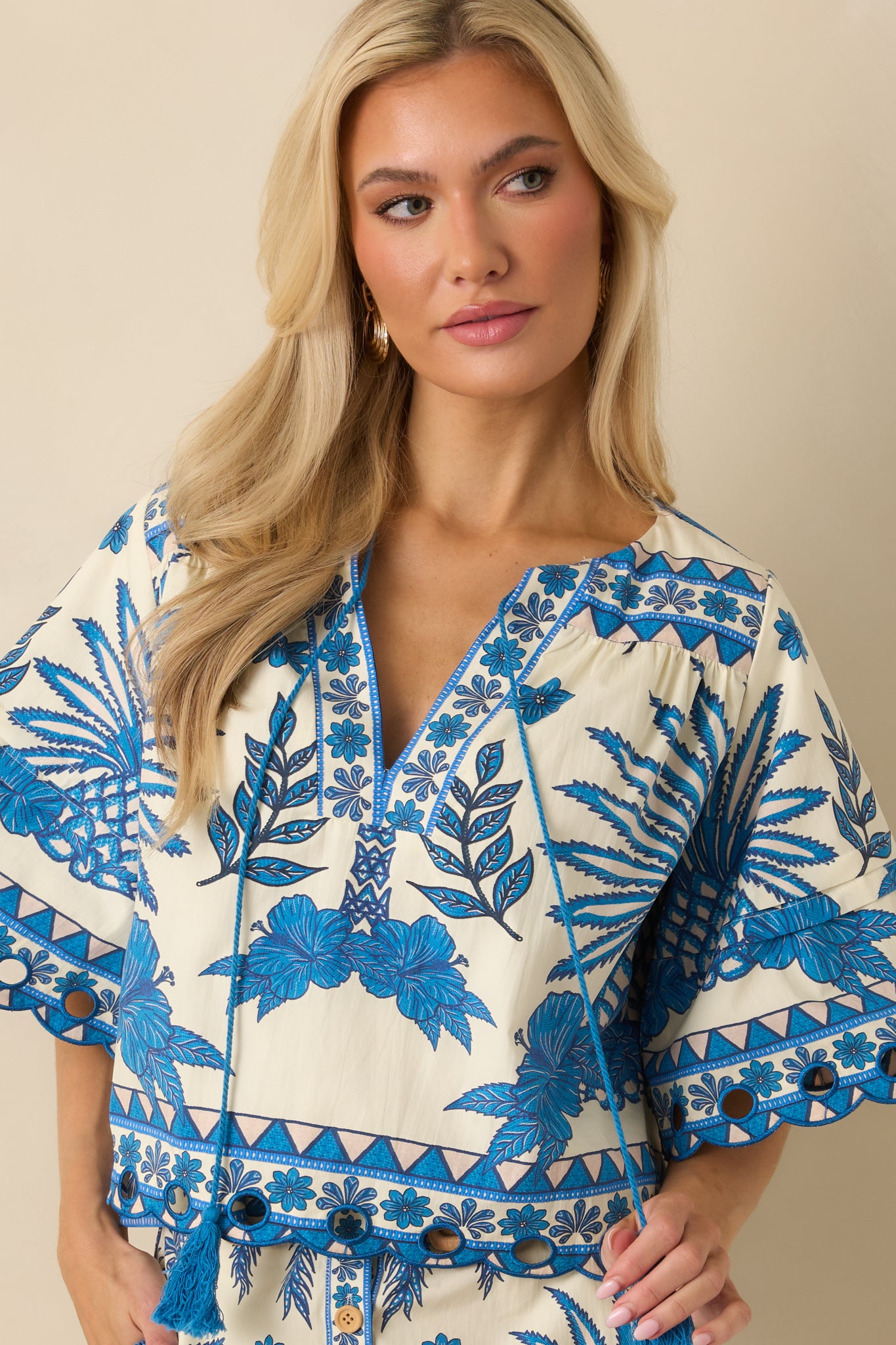 Cropped view emphasizing the short sleeves and decorative border detailing