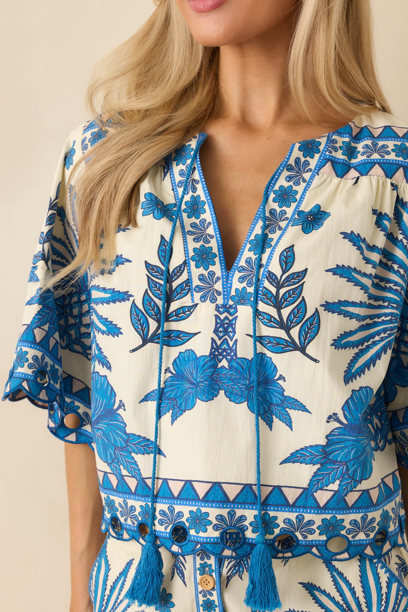 Close-up of the tassel accents and tropical print on the woven cotton fabric.