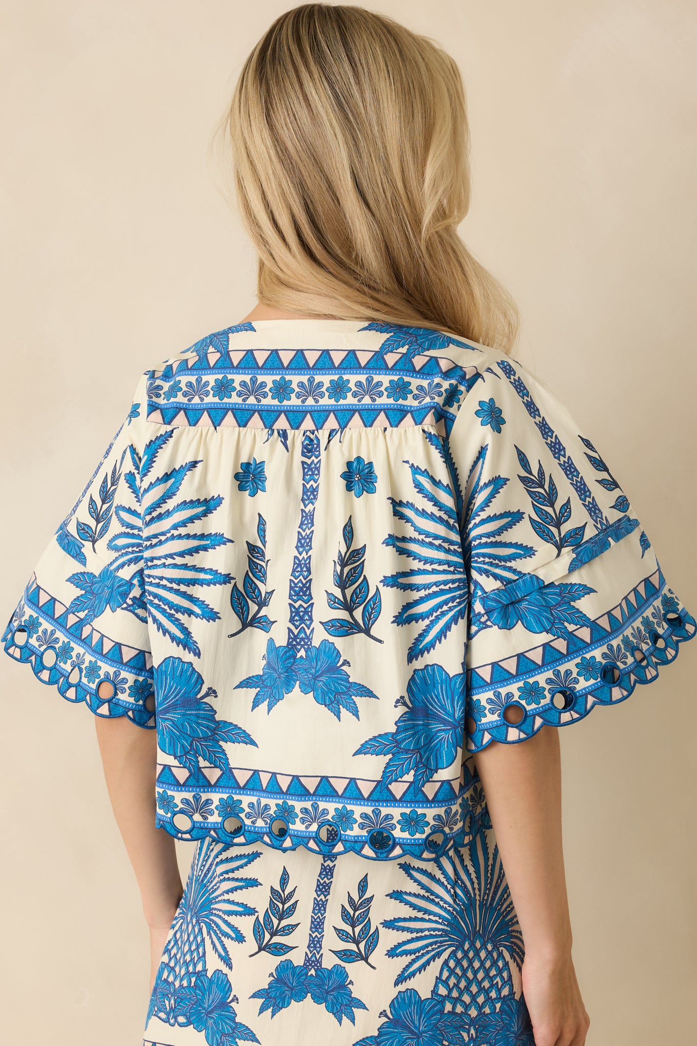 Rear view of the blue cotton top showing the relaxed fit and straight hem.