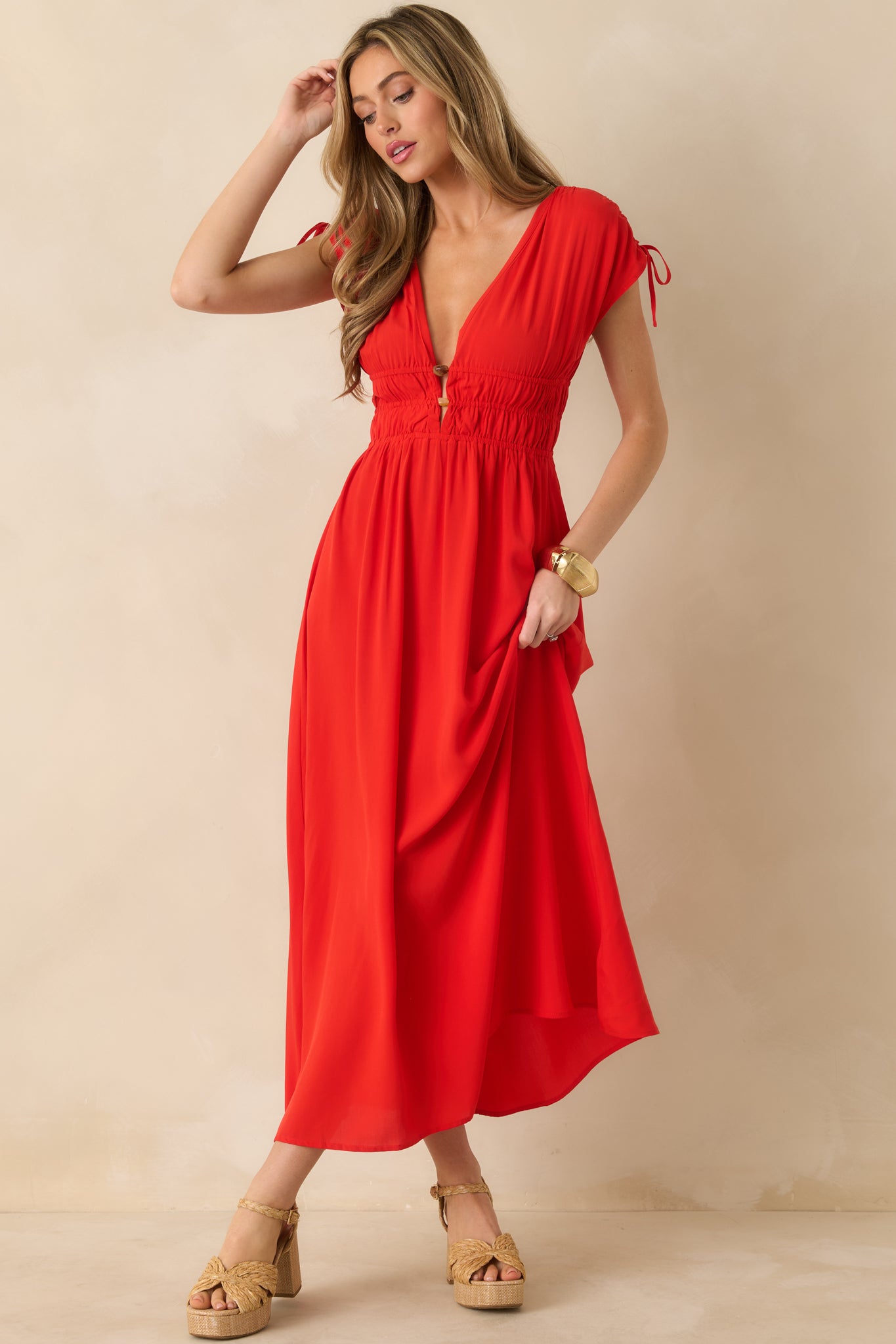 Flame-red midi dress showcasing the plunging neckline, gathered waist, and flowing draped skirt.