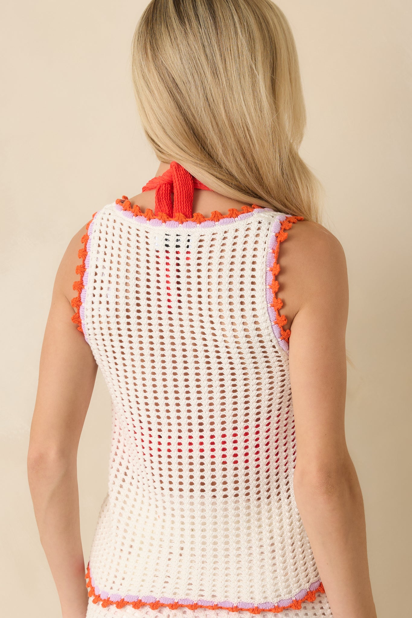 Rear view of the sleeveless top showing open-knit construction and straight hem.
