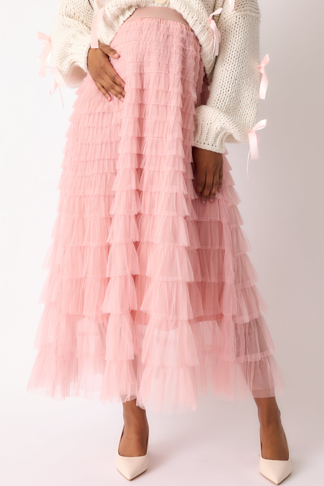 Cropped view of the dusty pink skirt’s tiered tulle design, emphasizing the flow and fullness of the fabric.