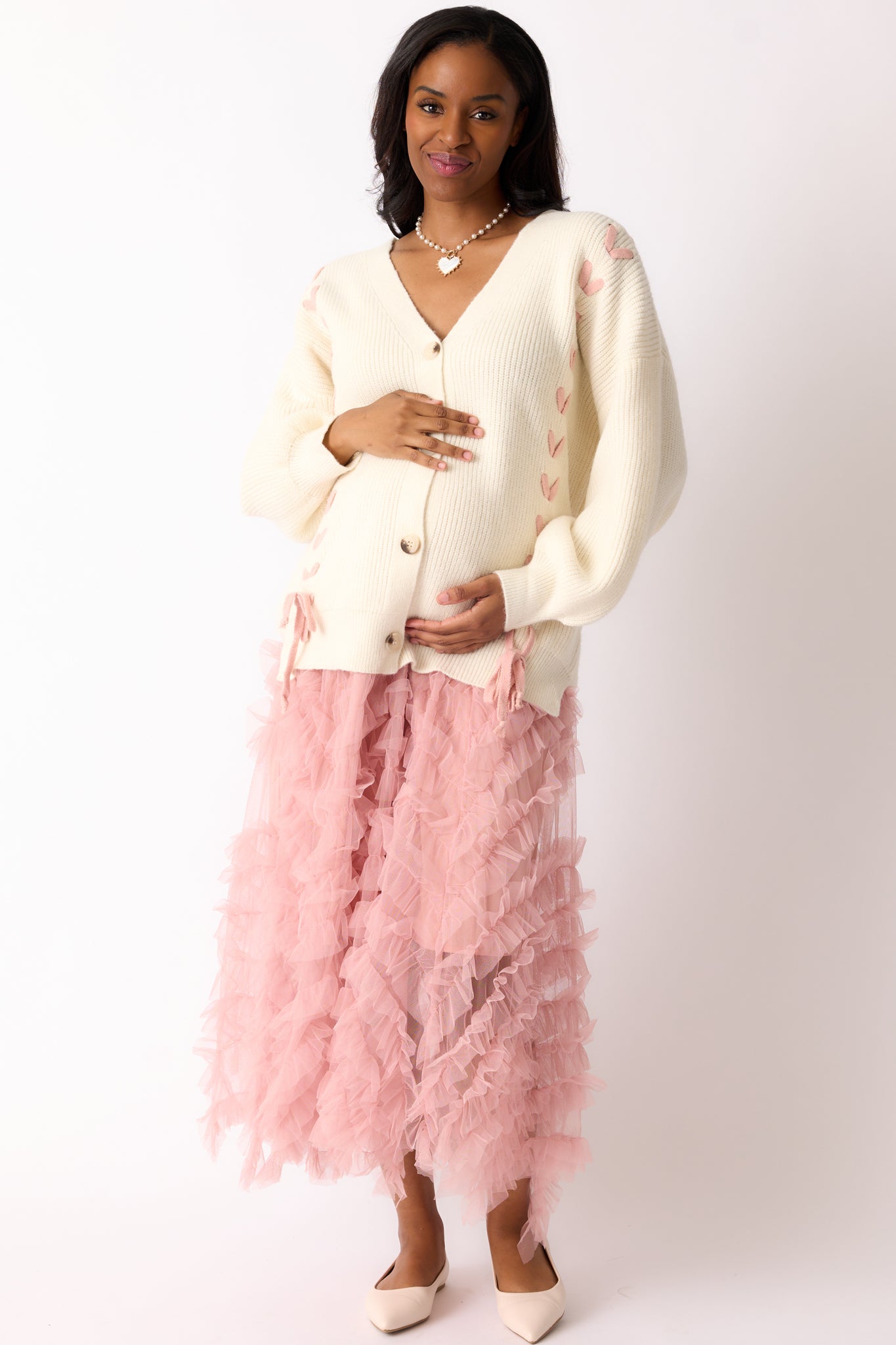 The ivory cardigan from the front, emphasizing the long sleeves with rib knit cuffs, bump-friendly design, and the overall relaxed fit.