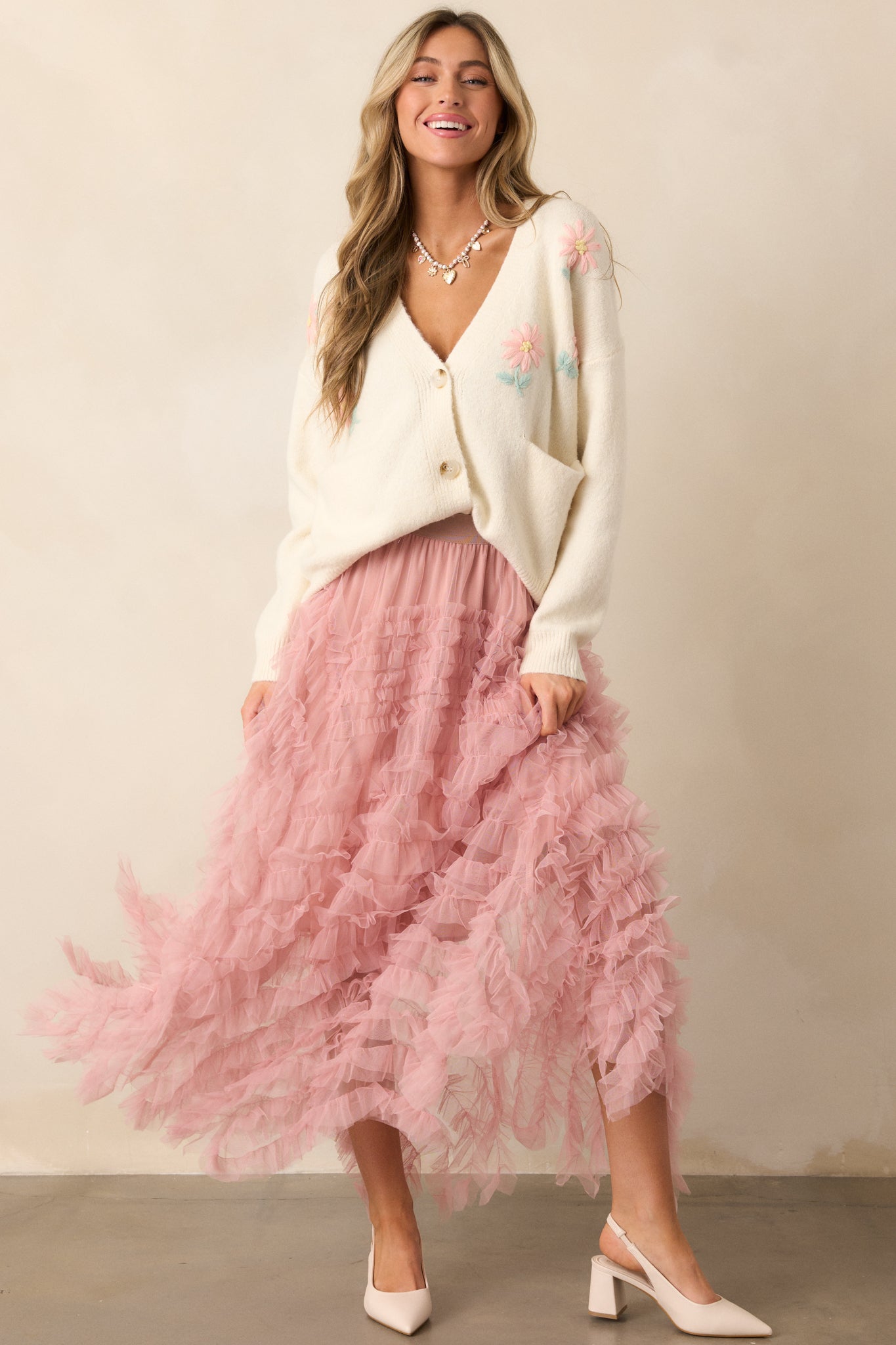 A complete view of the rose midi skirt, styled with rose ruffles and a flowy silhouette.