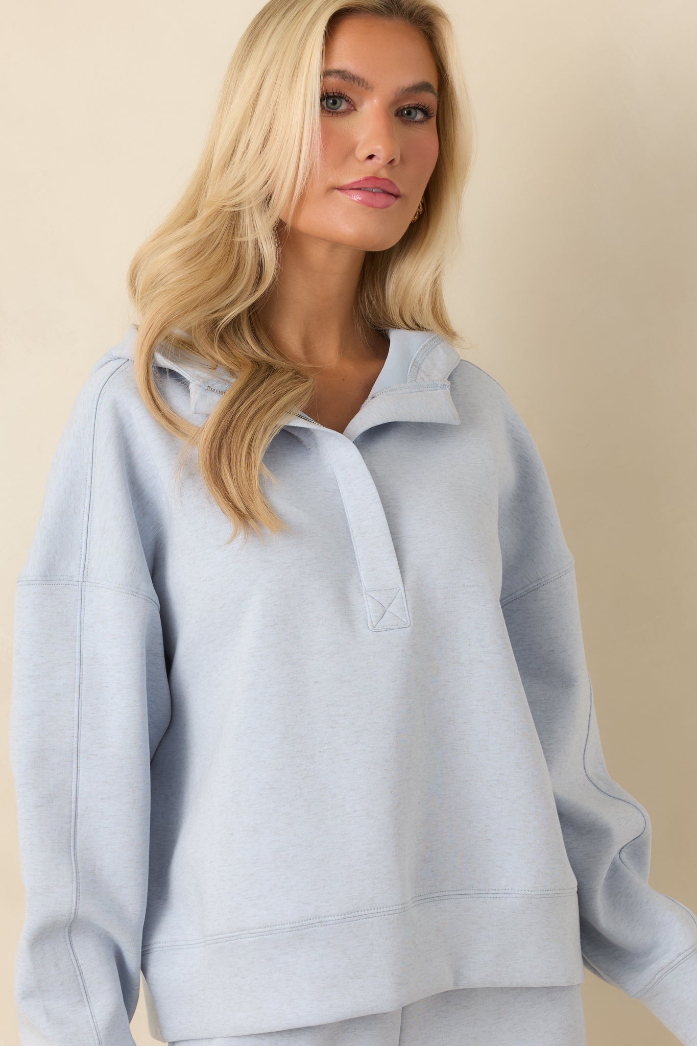 Partial zip neckline shown close, emphasizing the subtle seam lines.