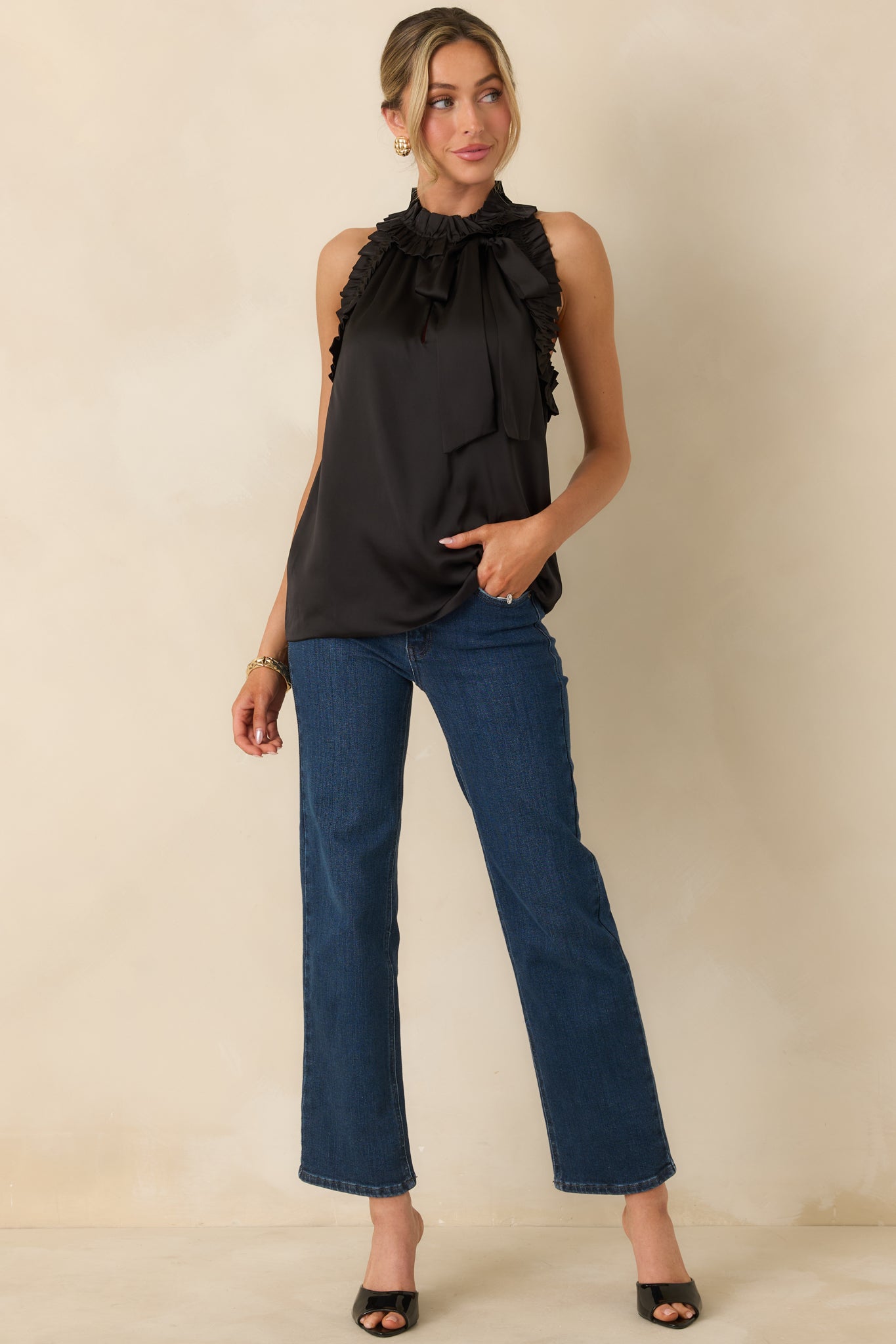 Black draped top with a high ruffled collar, relaxed fit, and delicate fabric texture.