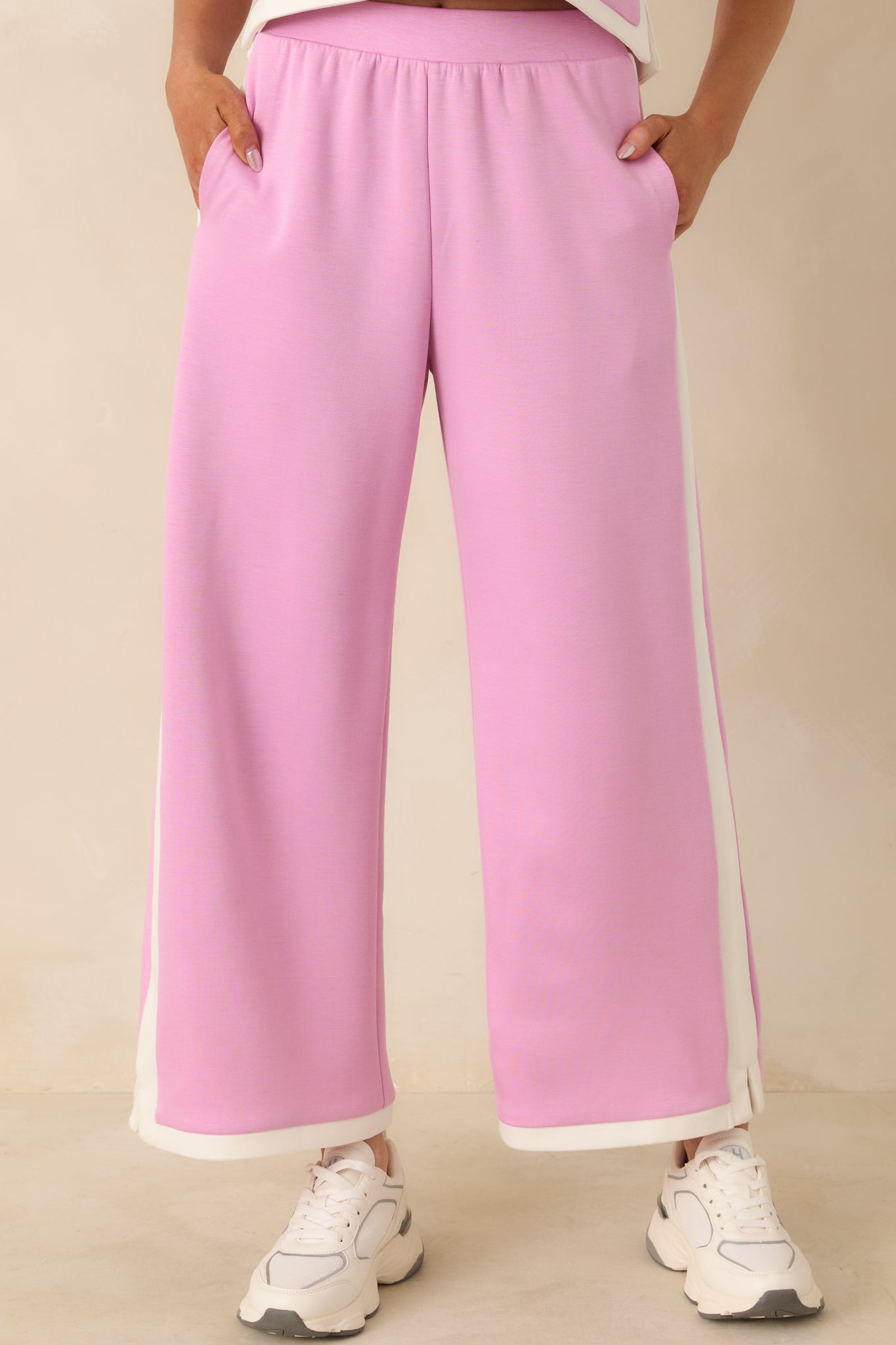 Orchid pink stretch knit texture with sharp contrast trim stitched along the outer leg.