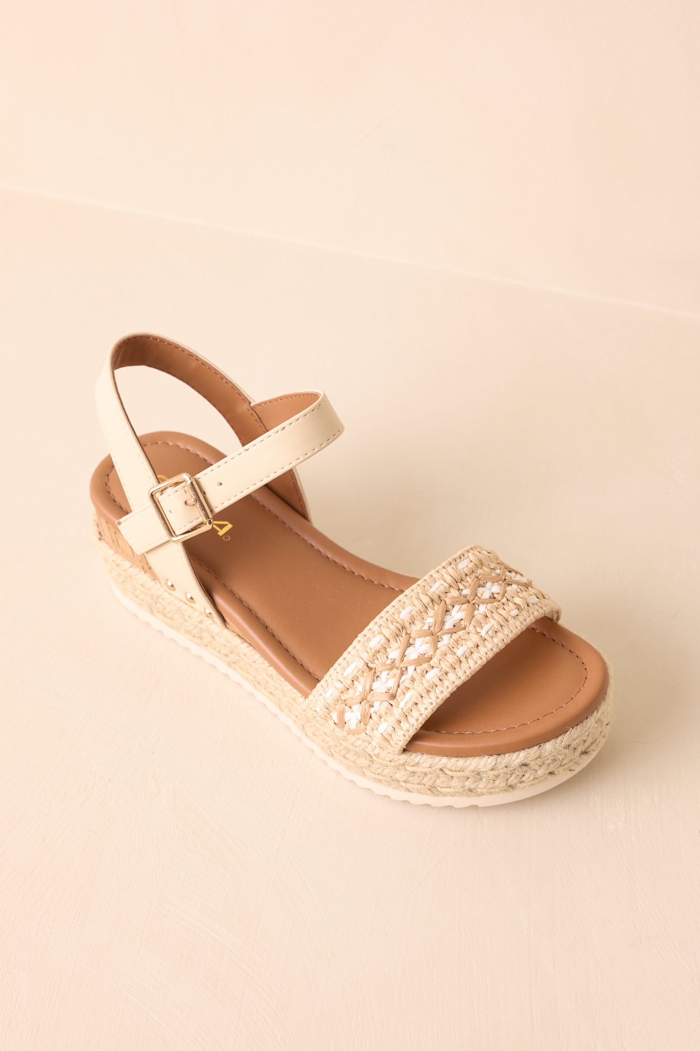 An overhead view of the wedges highlighting the woven raffia upper and wedge design.