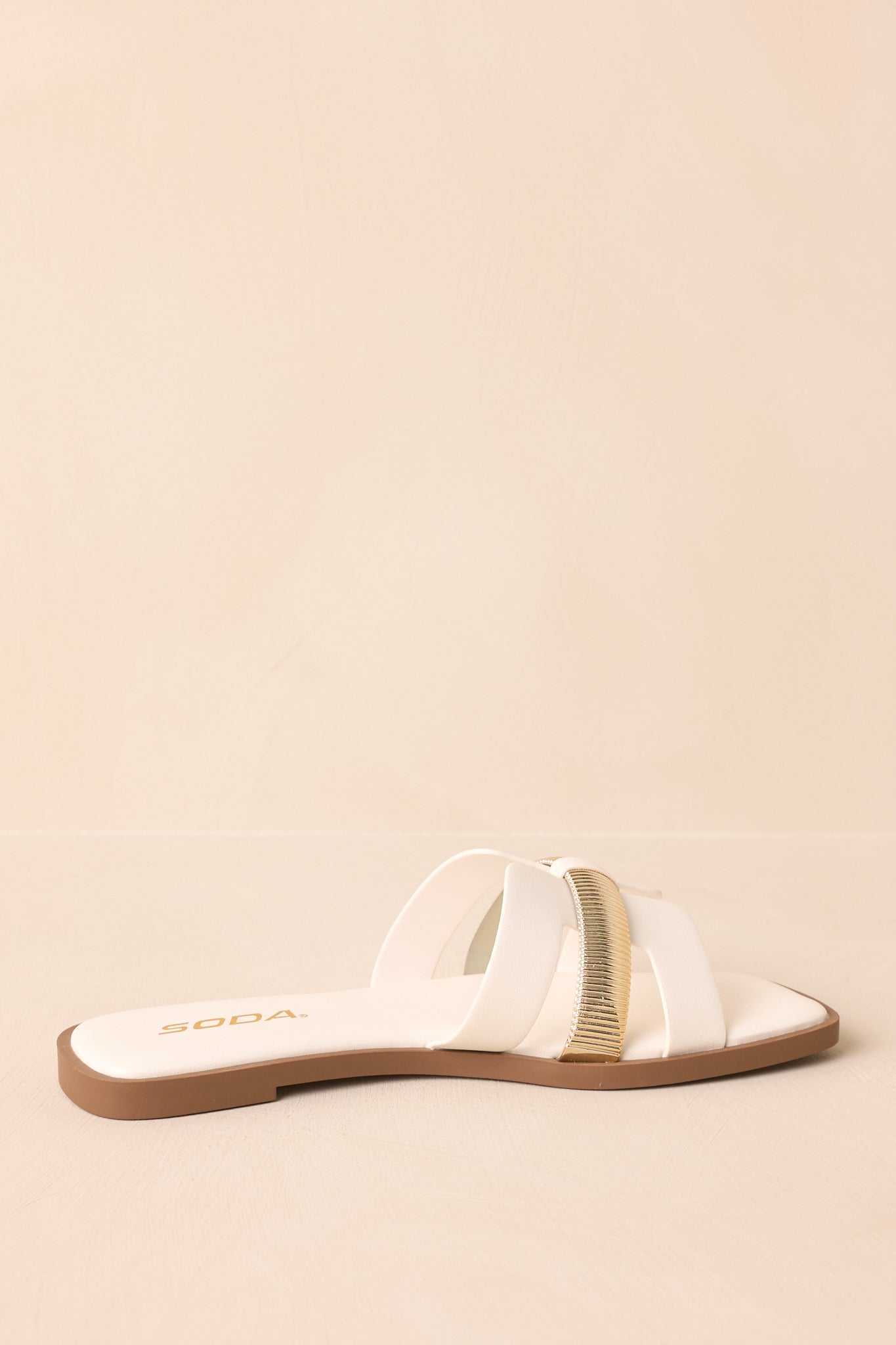 Rear view of the white sandals showing the heel and back cutout structure.