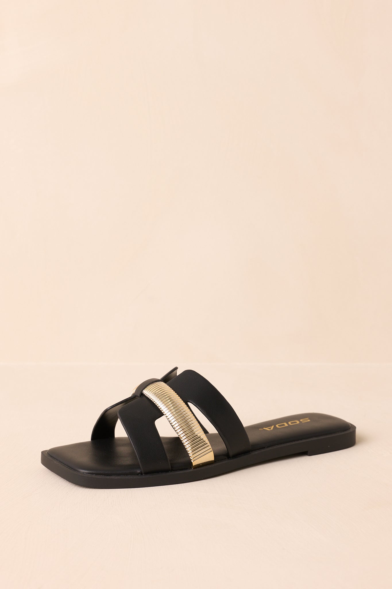 Angled shot showing the footbed and overall structure of the white sandals.