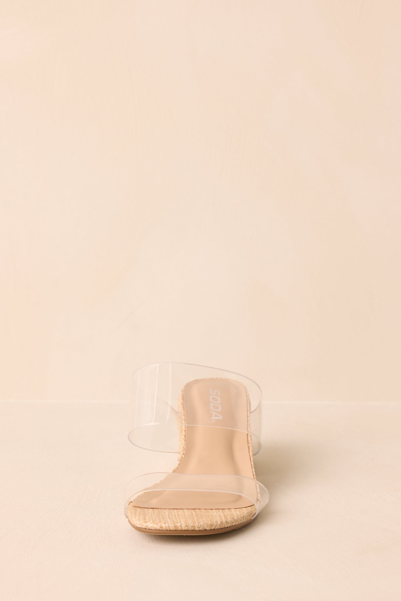 A front shot of the slide-on heels, focusing on the open-toe design and clear strap structure.