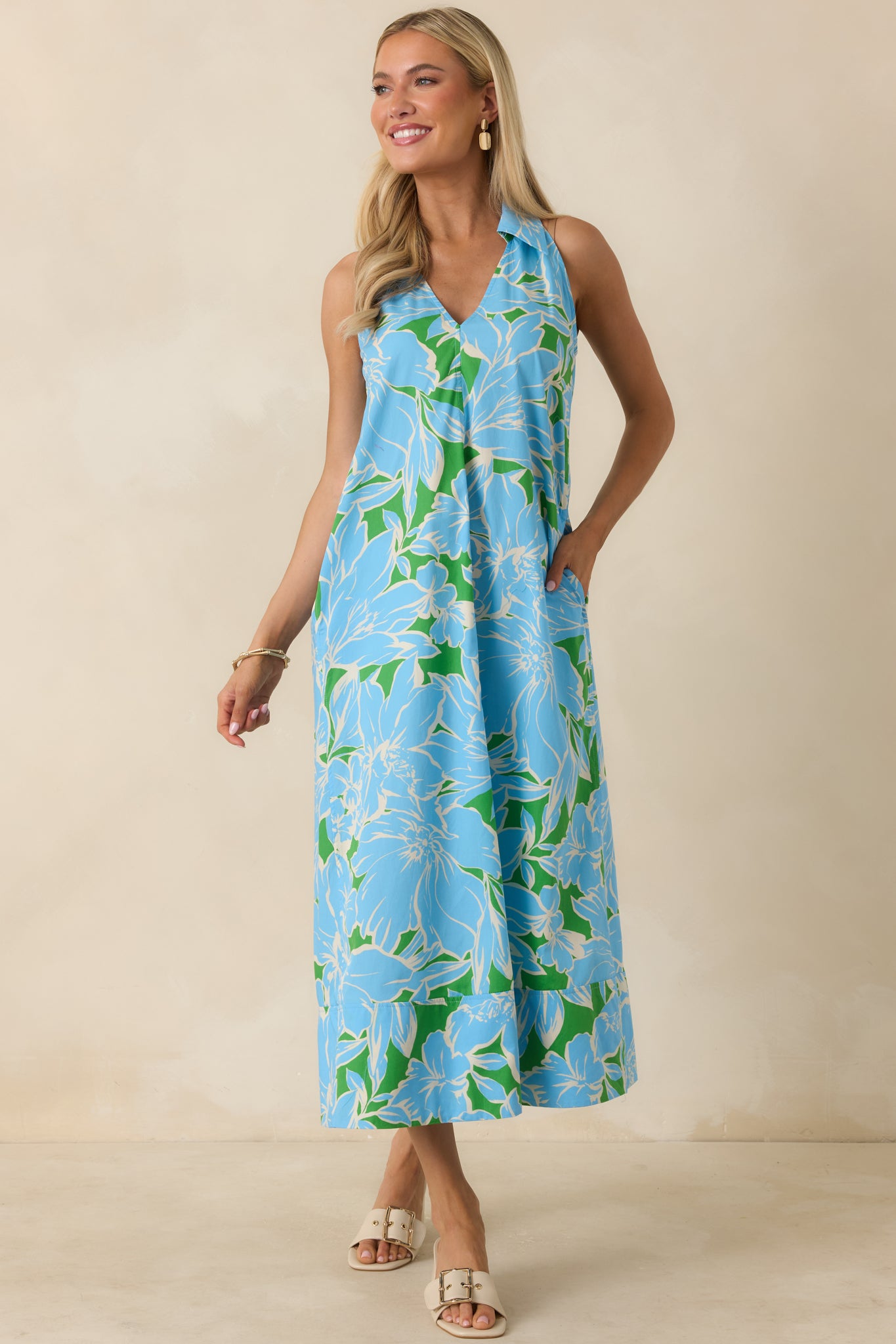 Floral cotton midi dress with a polished collar, relaxed pull-on fit, sleeveless design, and airy skirt with soft movement.