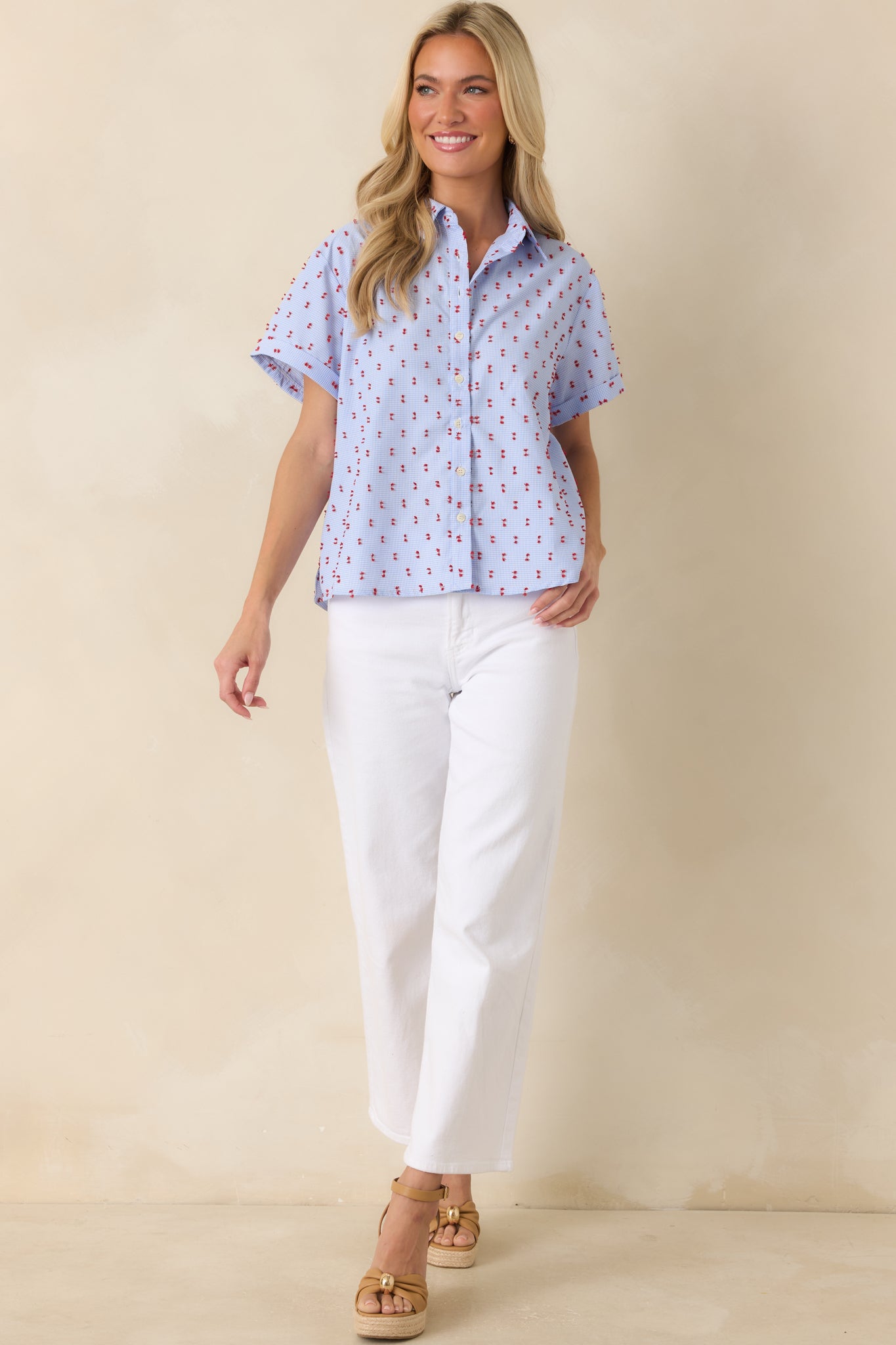 Lightweight cotton gingham shirt with a button-front closure, vibrant red embroidered accents, and an easy fit.