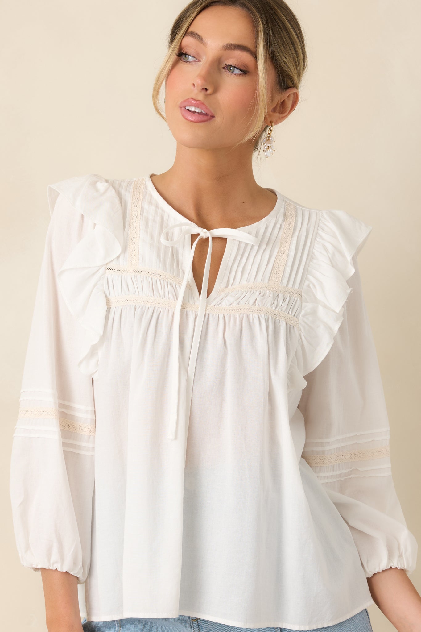 Detail view of delicate lace panels and lightweight flowy fabric.