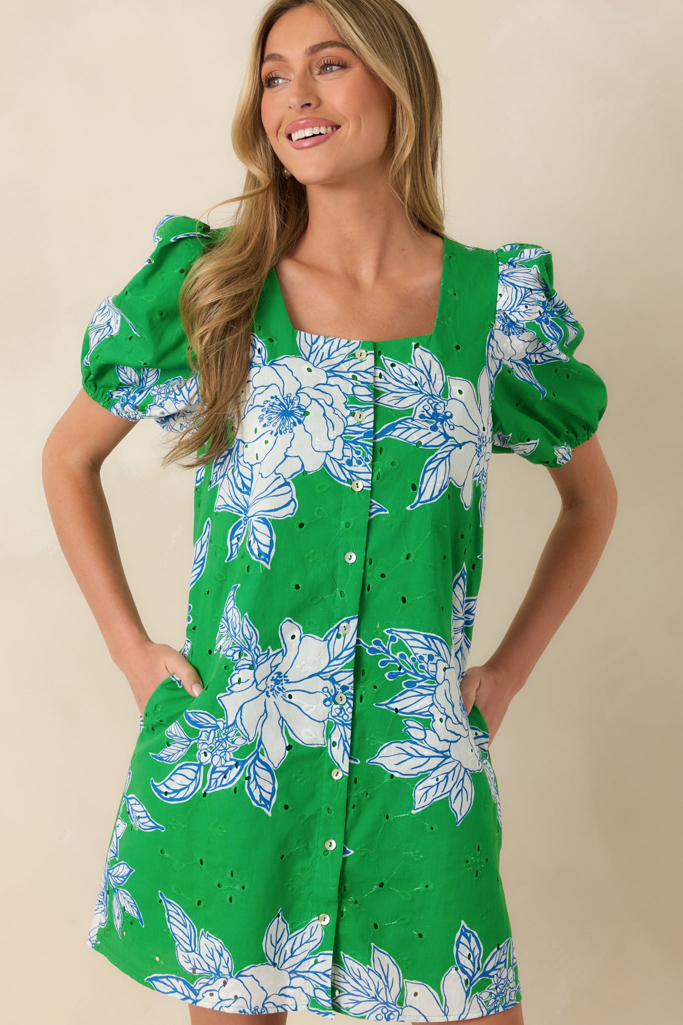 Green and white floral shift dress with side pocket detail and relaxed drape.