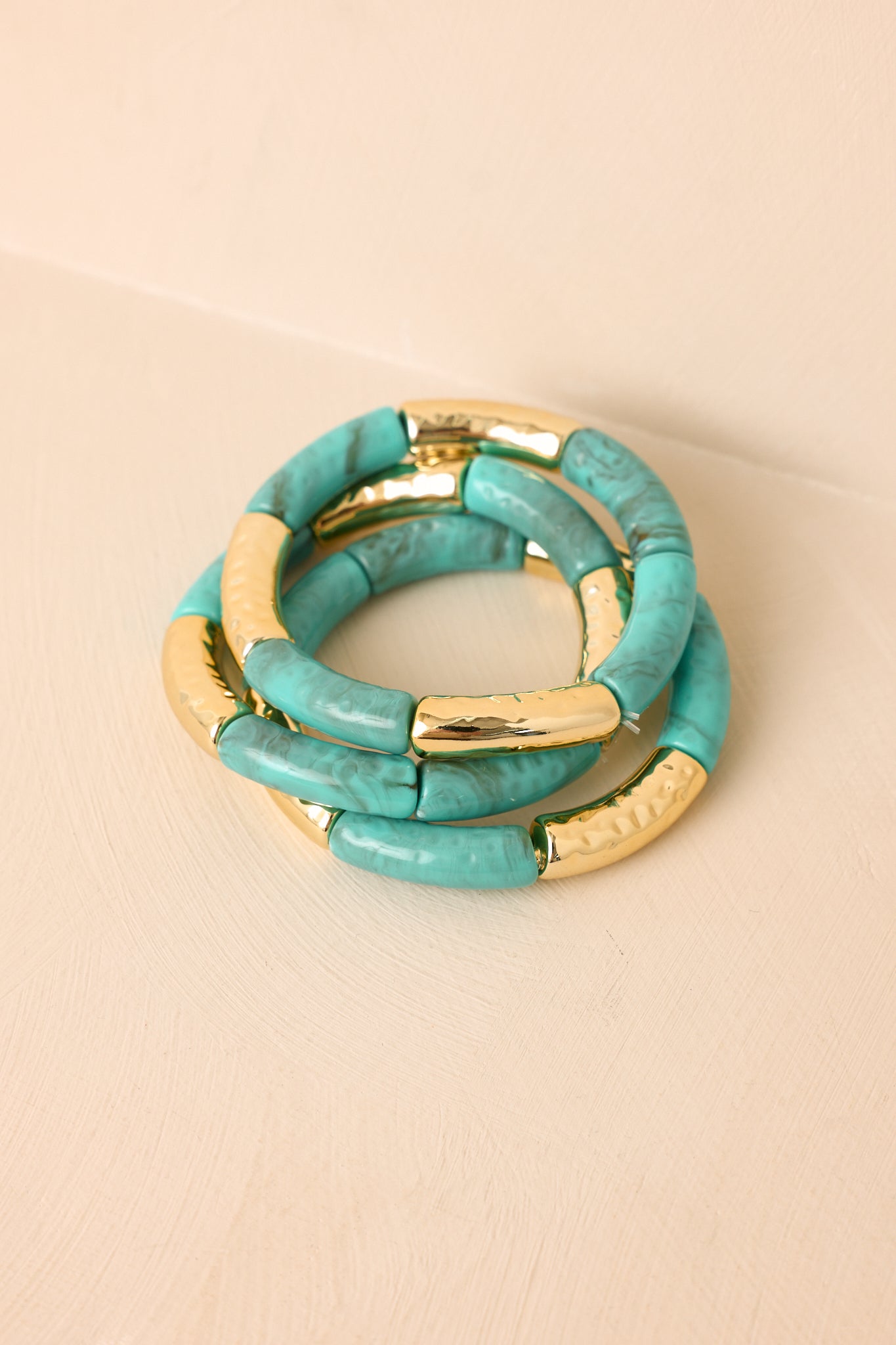 Layered bracelet set highlighting turquoise-inspired beads, gold accents, and comfortable stretch silhouettes.