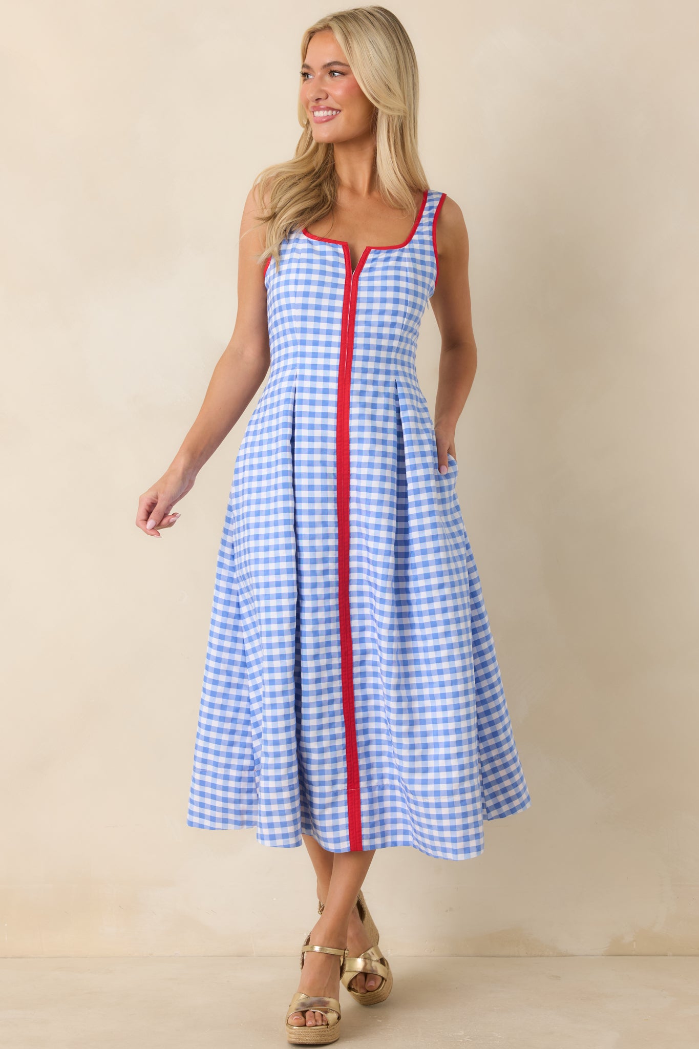 Blue and white gingham dress featuring a tailored bodice and hidden side zipper closure.