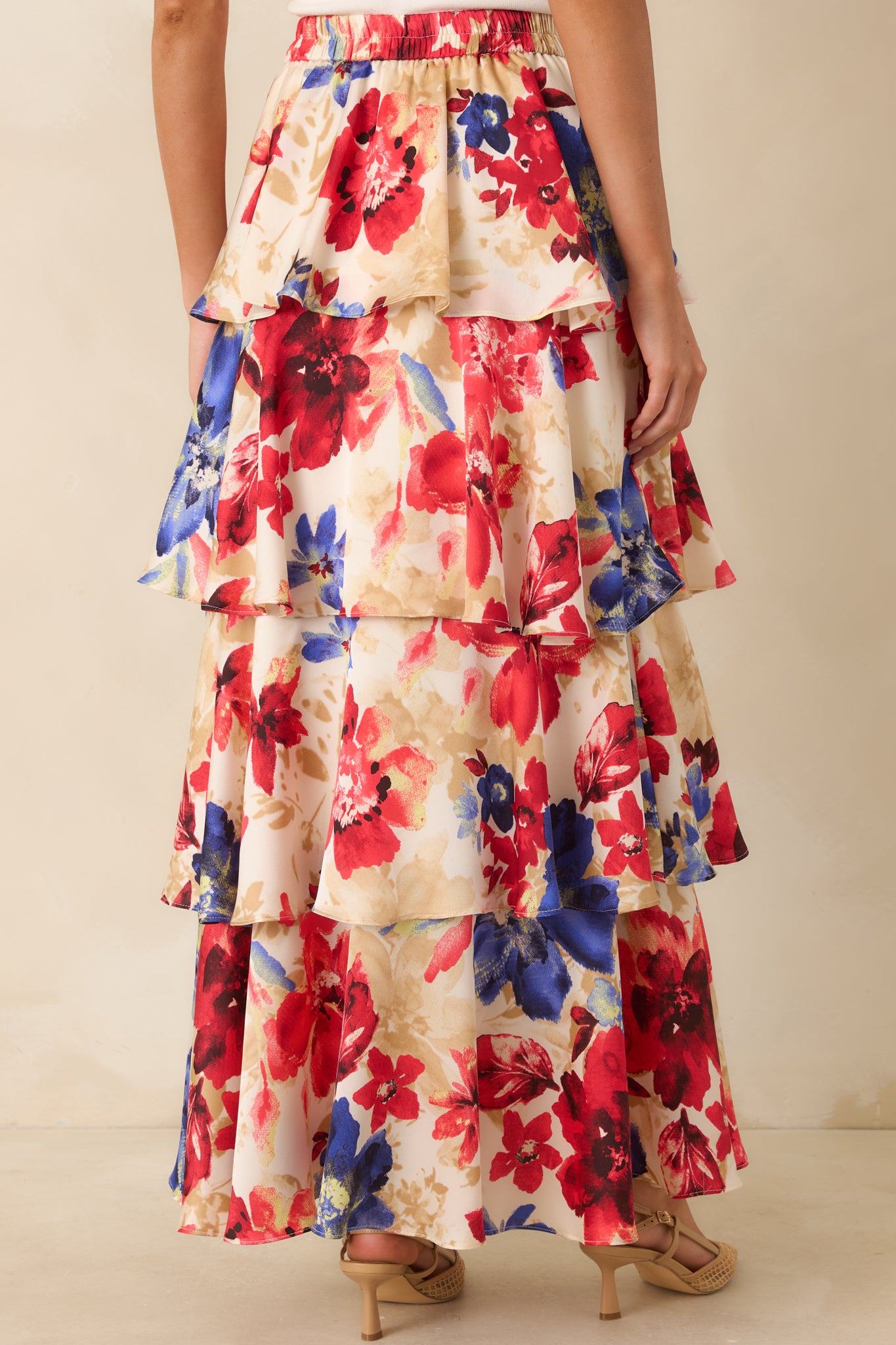 Rear view of the maxi skirt showing the elastic waistband and flowing tiered silhouette.