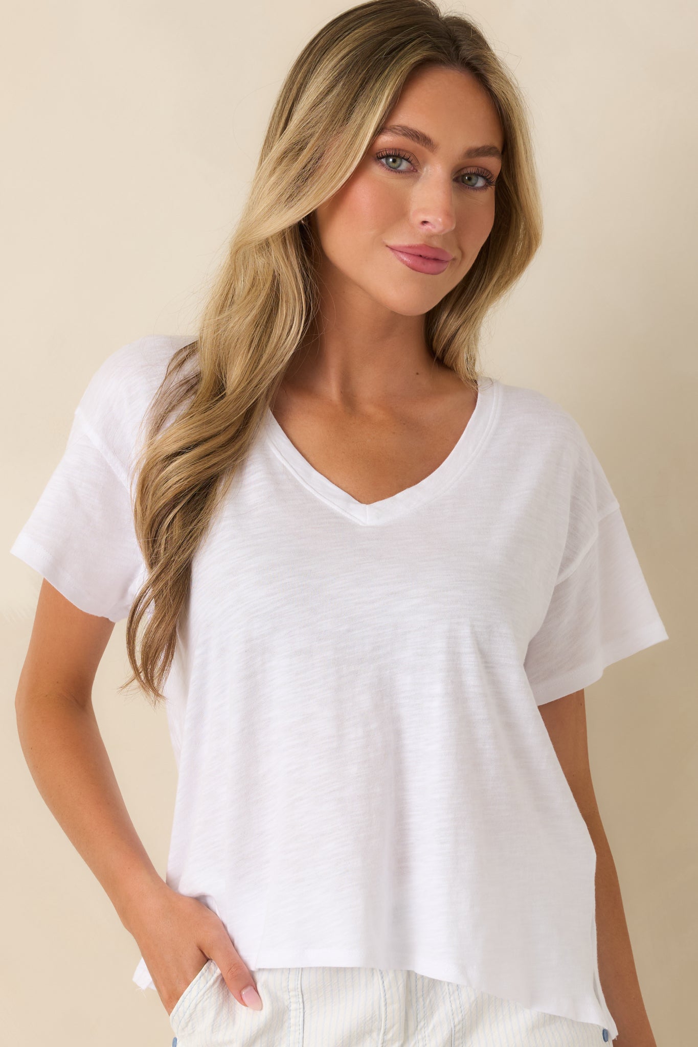 Front close-up of white t-shirt emphasizing clean neckline stitching and smooth fabric finish.