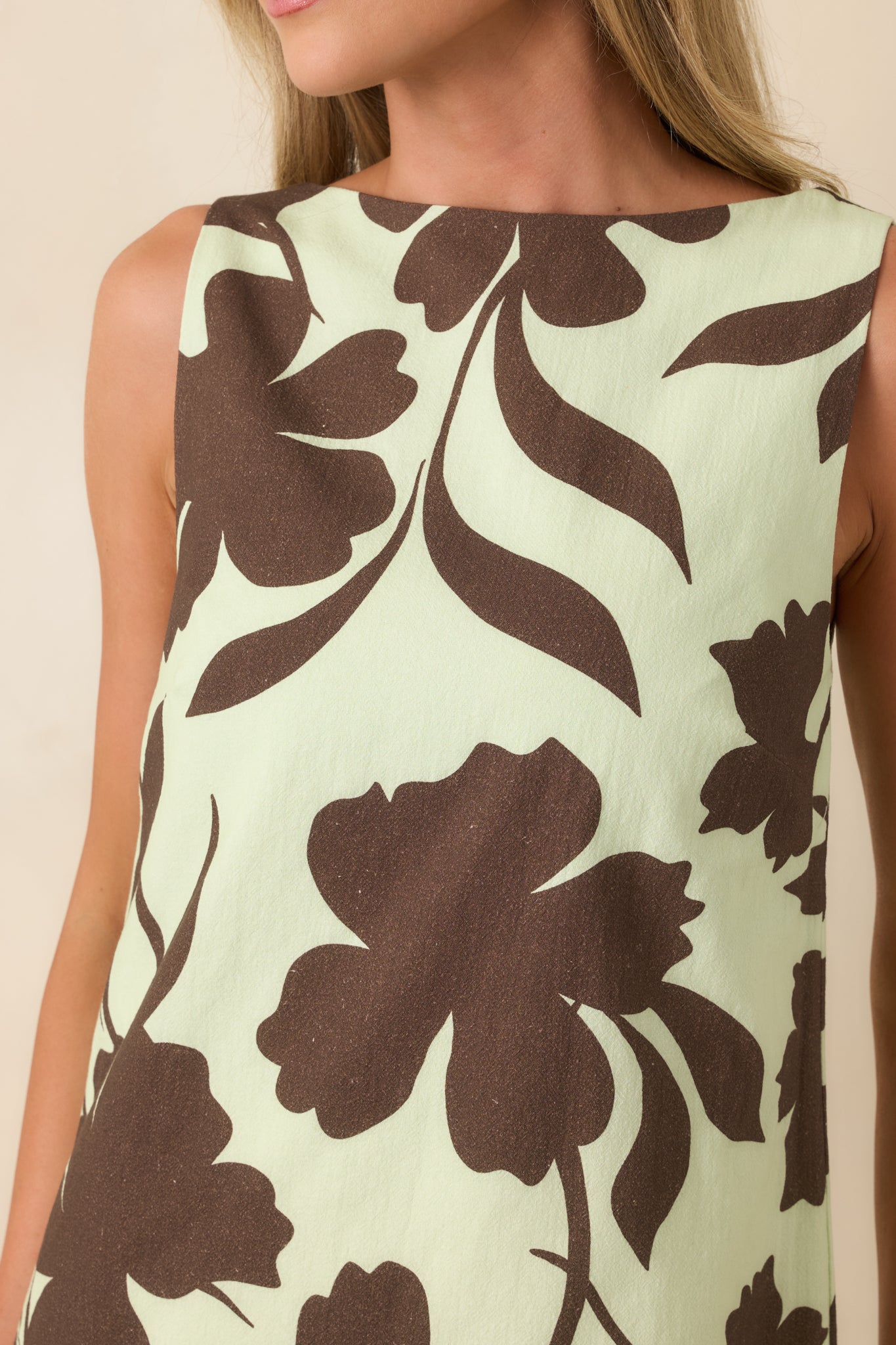 Close-up of chocolate floral fabric on mint base showing cotton weave and print clarity.