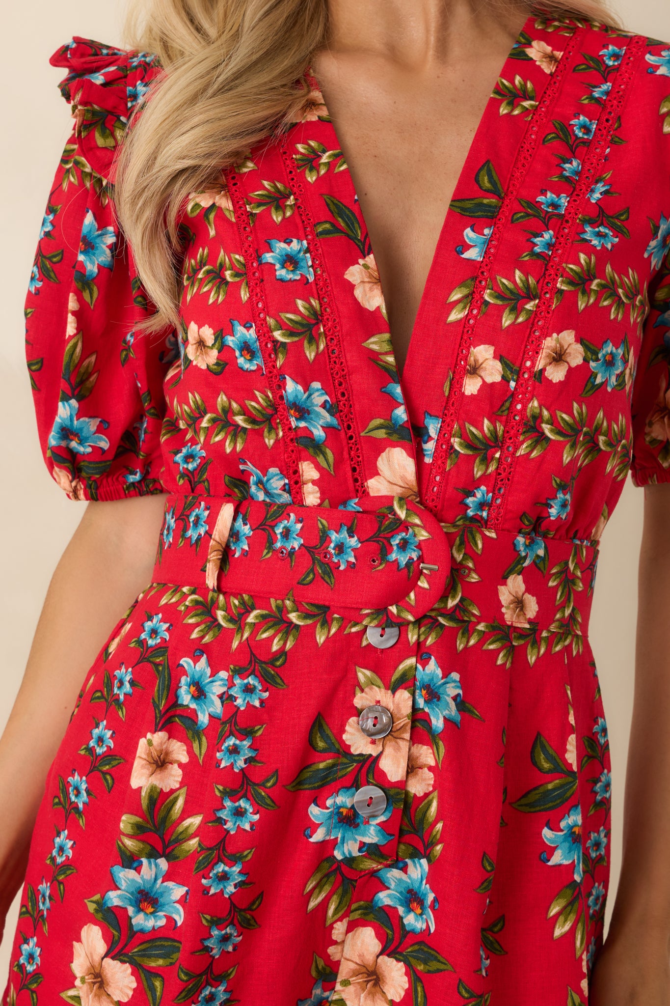Close-up of the red floral print with button detailing and lightweight linen blend texture.