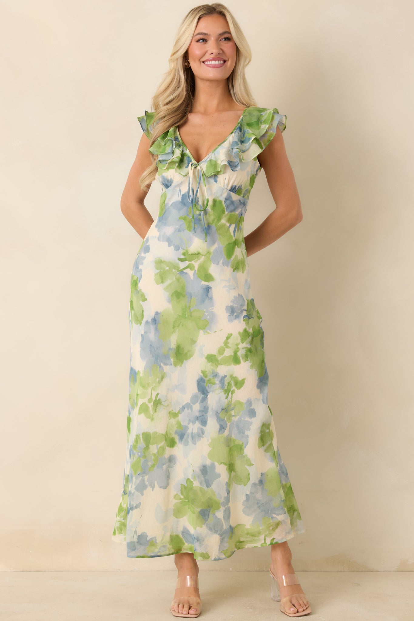 Painterly floral midi dress with feminine V neckline, delicate tie accent, and fluttery cap sleeves.