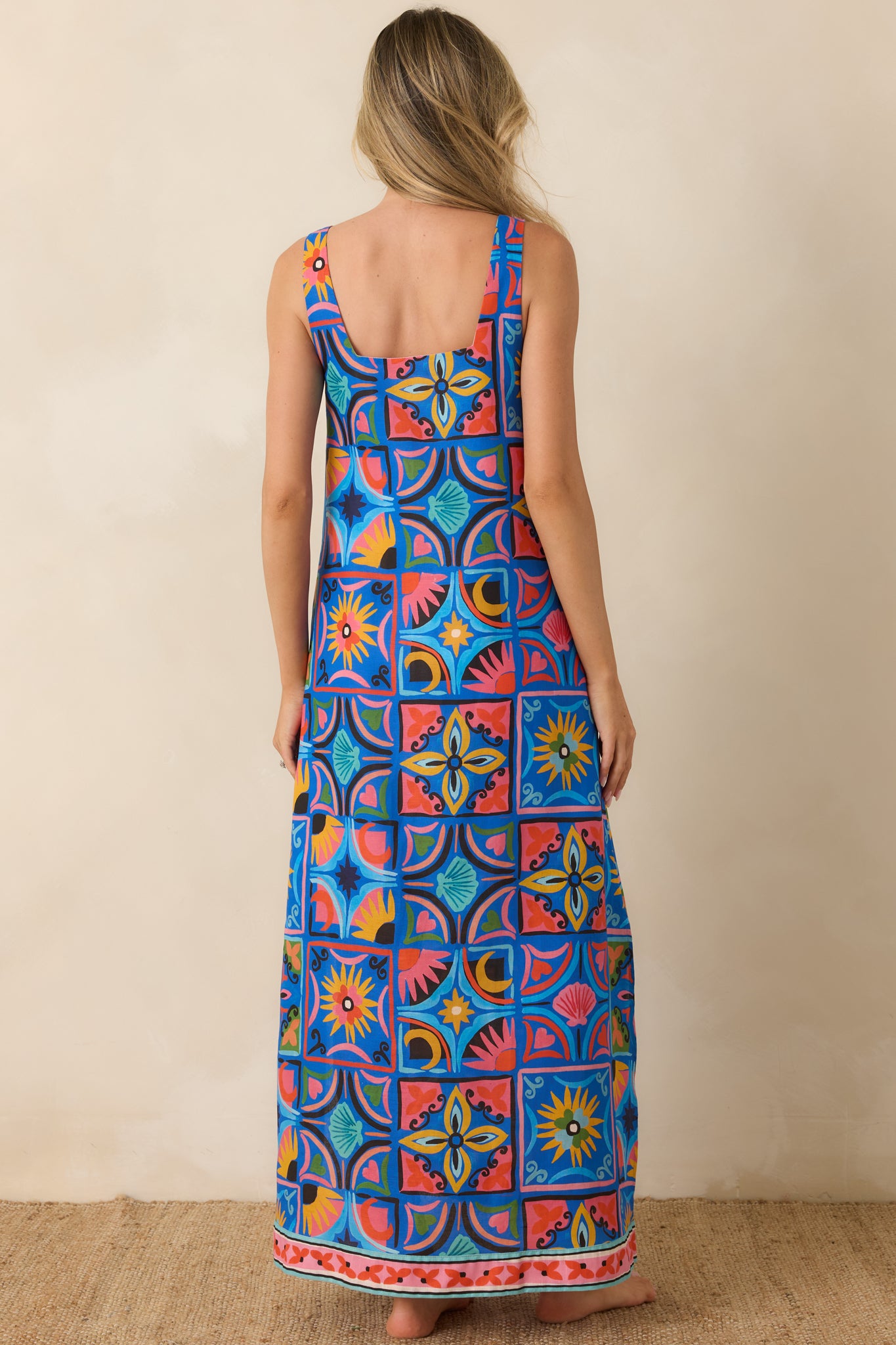 Rear view of the blue tile print maxi dress featuring wide shoulder straps, a relaxed flowing silhouette, and full-length hem.
