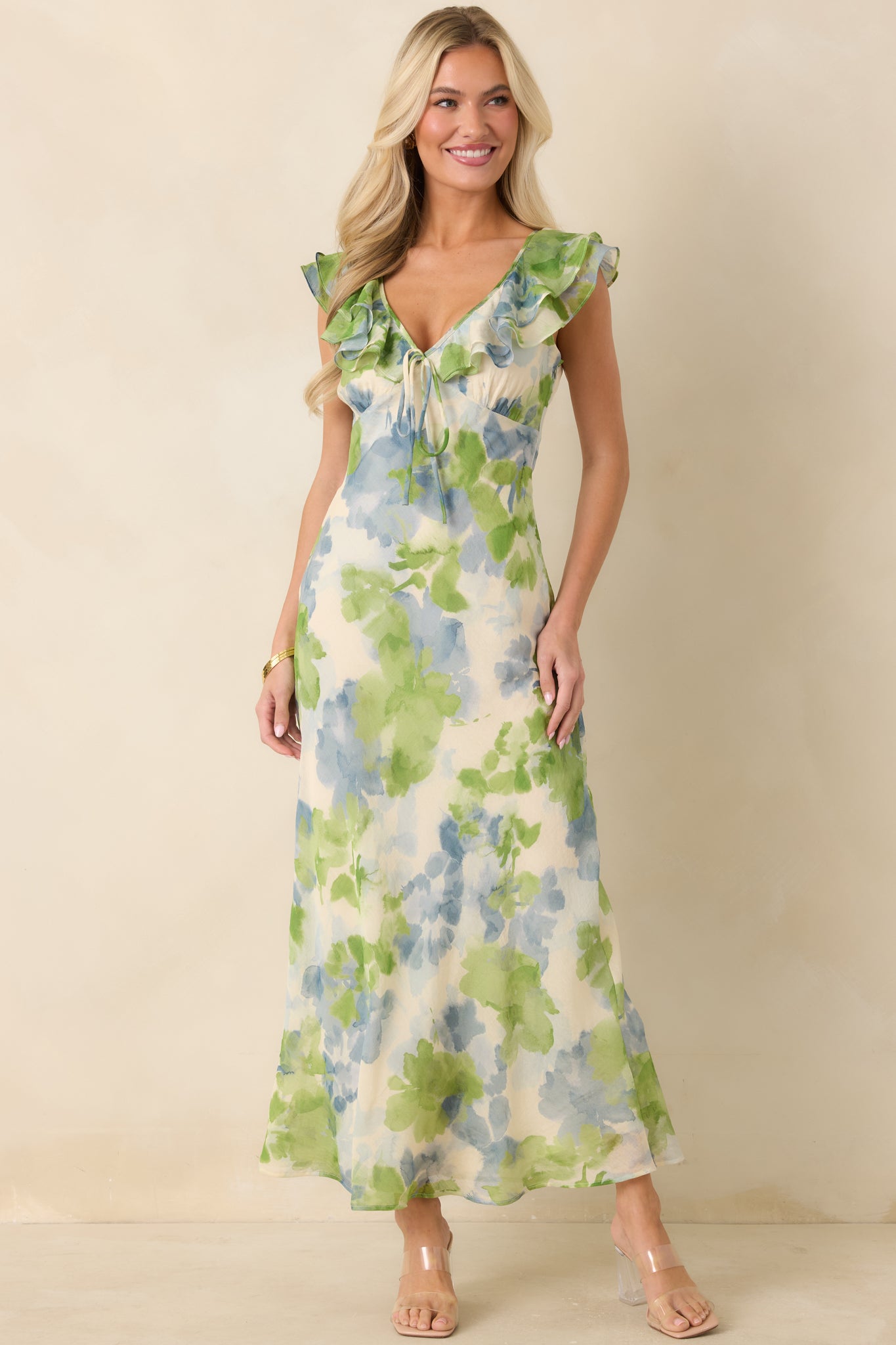 Lightweight midi dress with blue green floral print, gently shaped bodice, and soft movement.