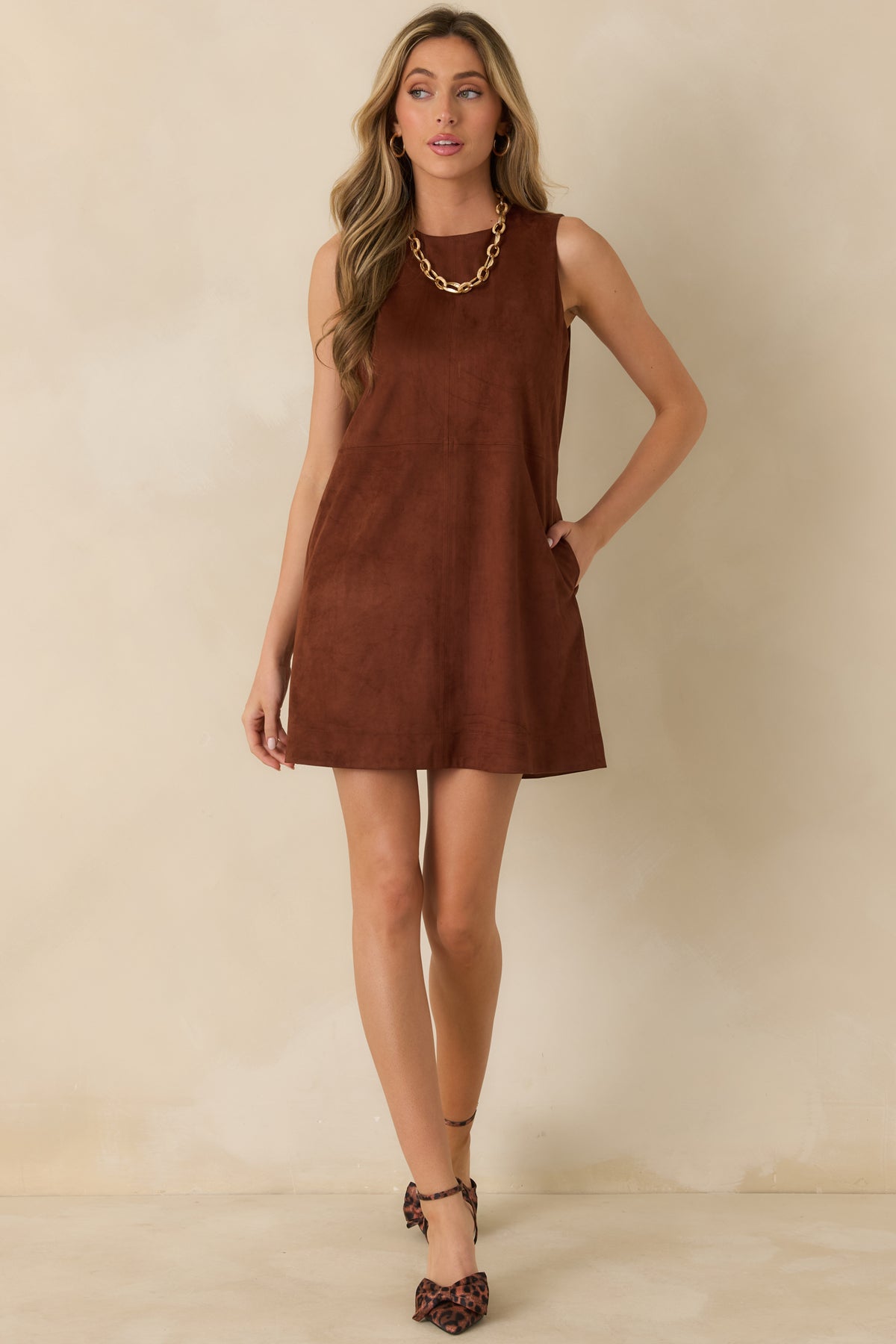 A classic round neckline and subtle seam detailing define the cognac faux suede dress with its relaxed shape.