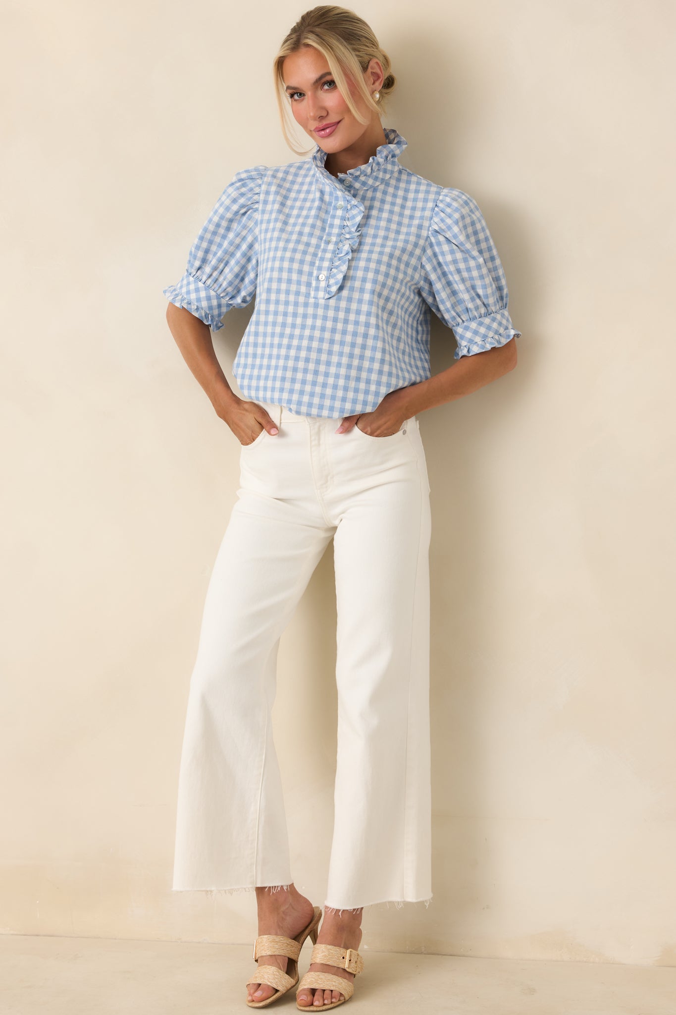 Lightweight cotton top with softly puffed sleeves and ruffled button placket.