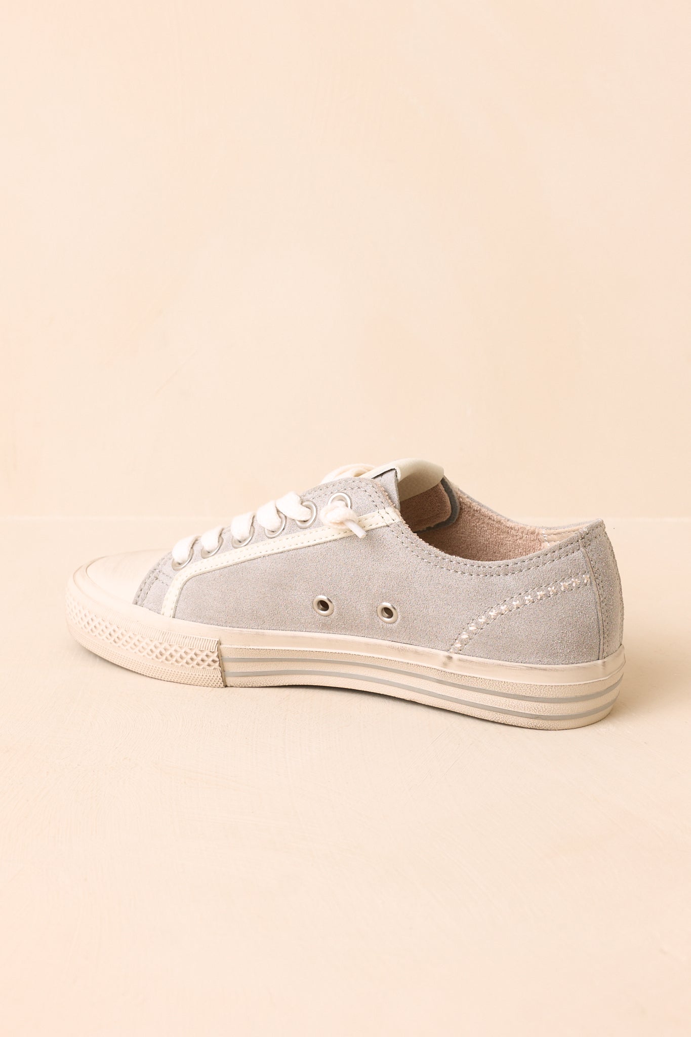 Rear view of the dusty blue suede sneakers highlighting the heel construction, rubber sole, clean back profile, and soft suede finish.