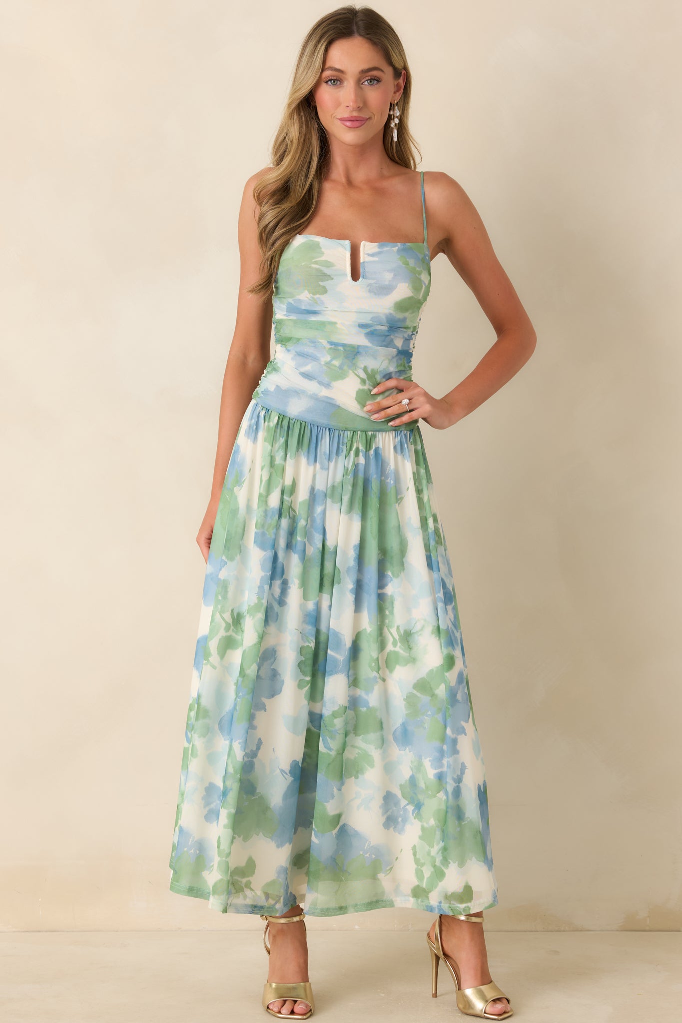 Watercolor print maxi dress with ruched bodice, lined finish, and gracefully draped skirt.