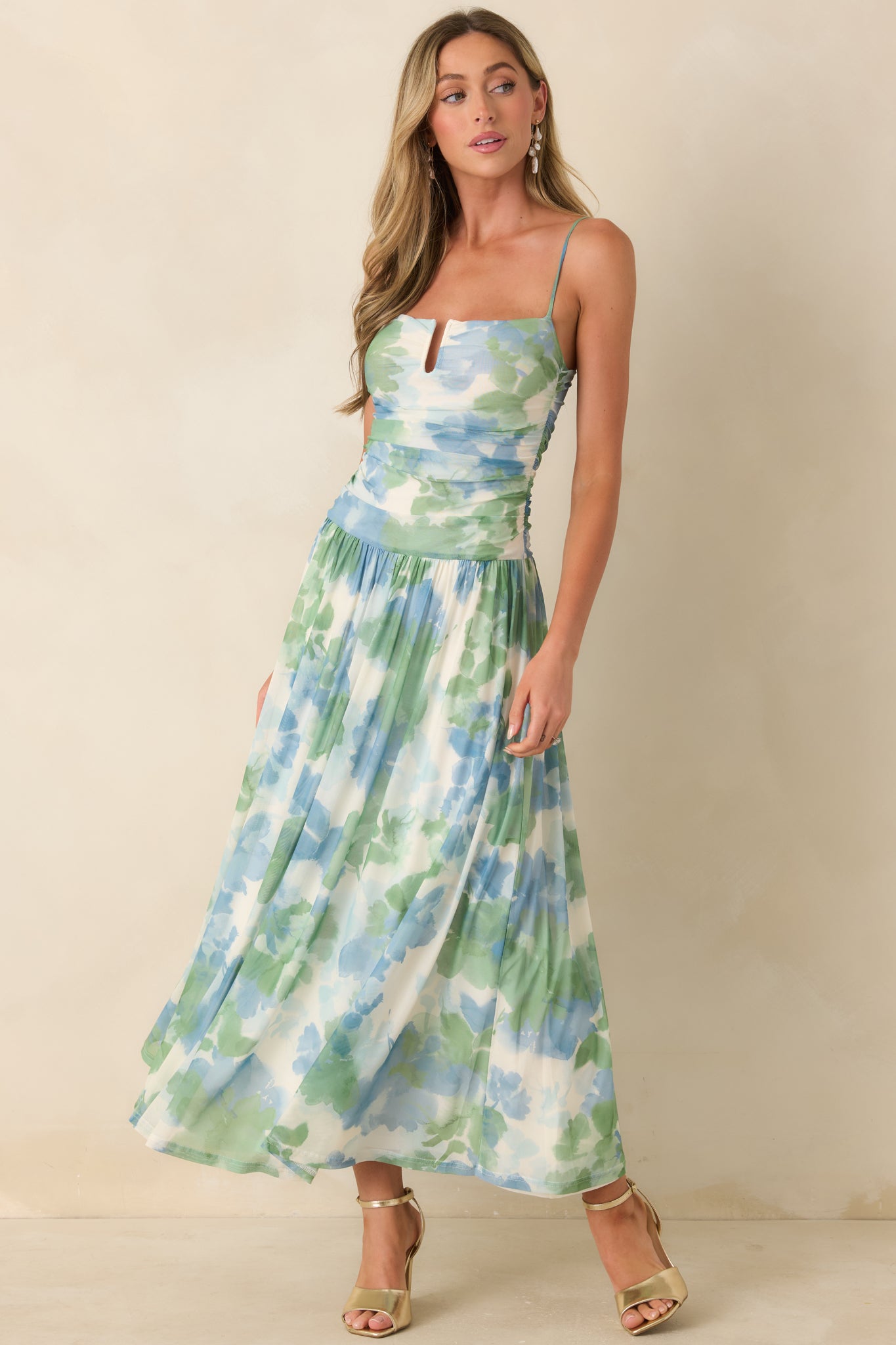 Blue and green watercolor maxi dress with ruched bodice, notch neckline, and flowing mesh skirt.