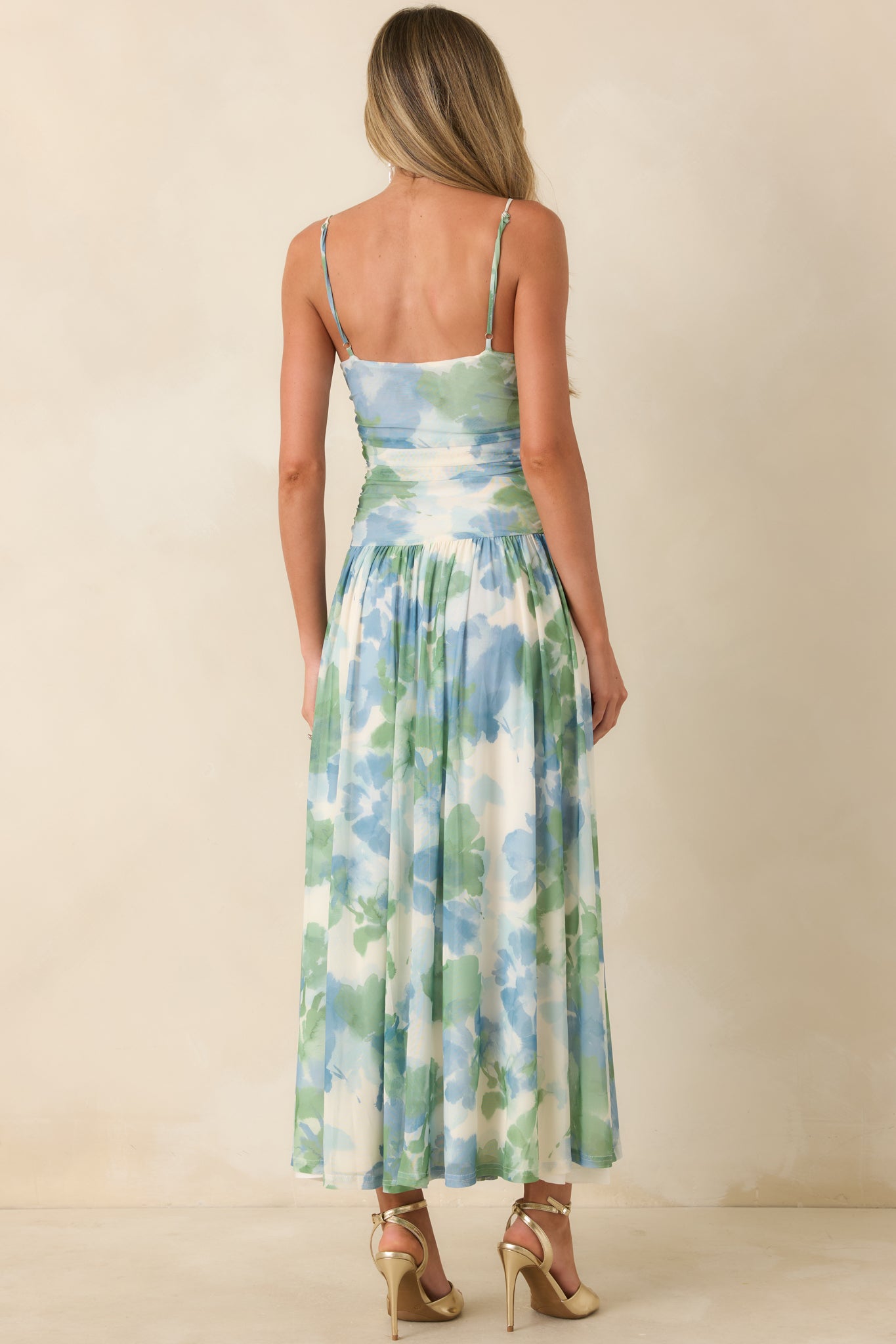 Rear view of watercolor mesh maxi dress with adjustable straps and flowing skirt.