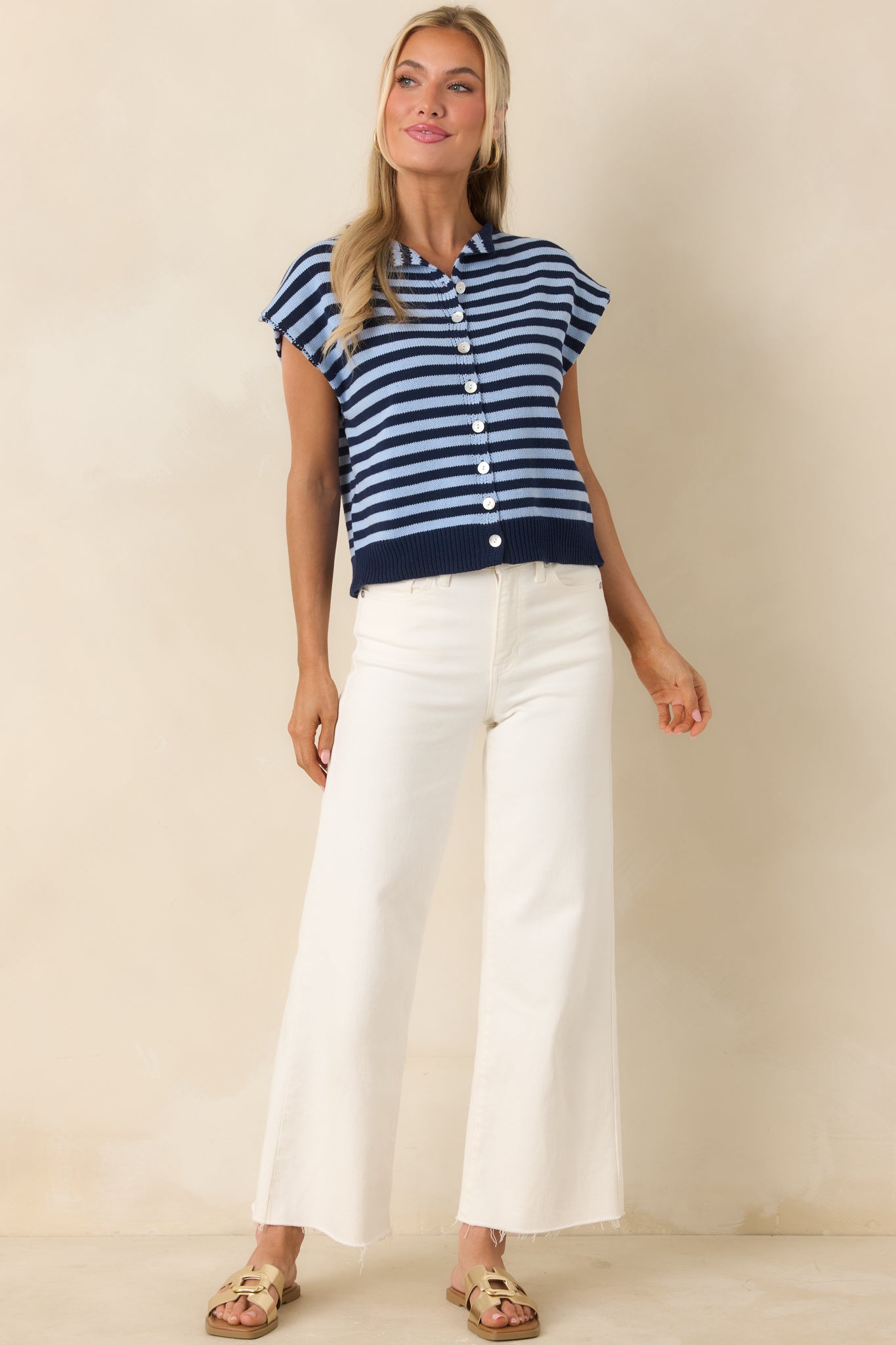 Horizontal striped knit top featuring cap sleeves and relaxed polished silhouette.