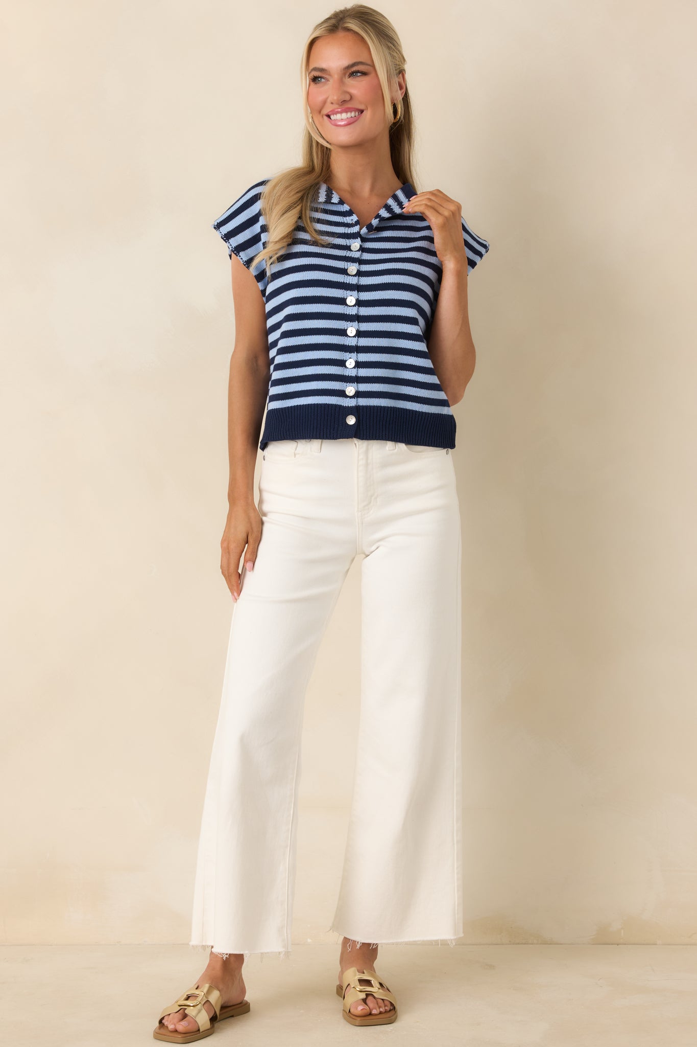 Lightweight knit top with classic stripe pattern and pearlescent-style buttons.